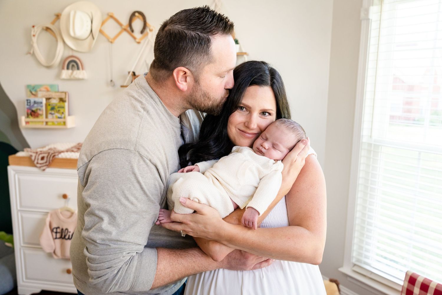 Intimate lifestyle photography session in a naturally lit nursery room.