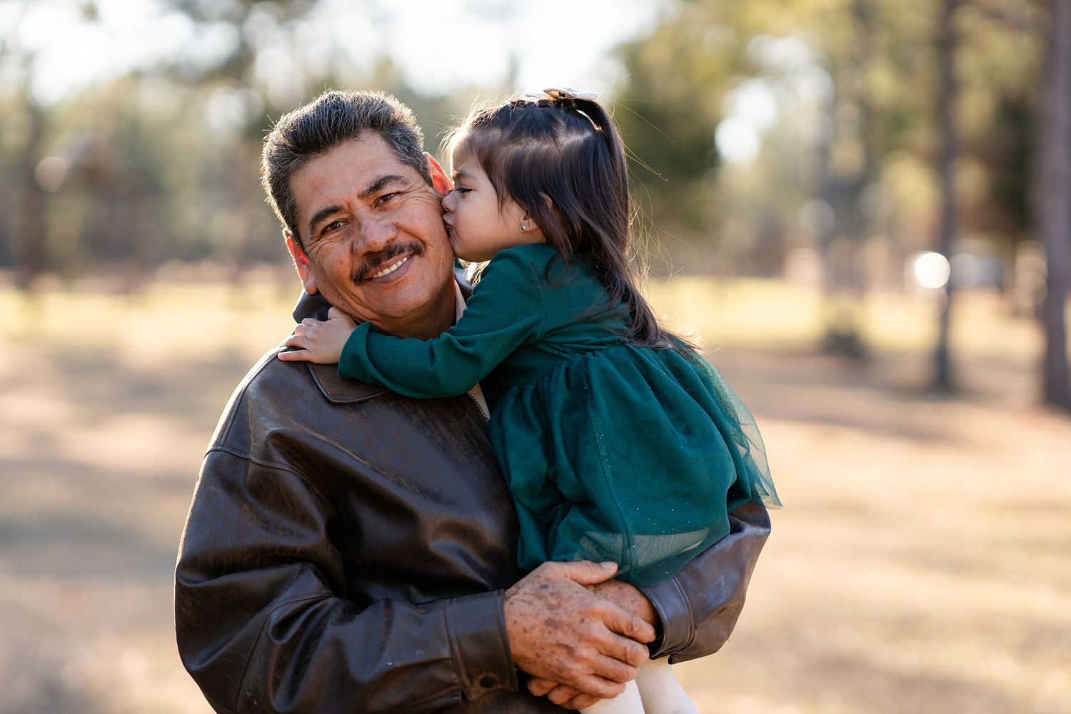 A tender moment shared between family members during a golden hour photoshoot.