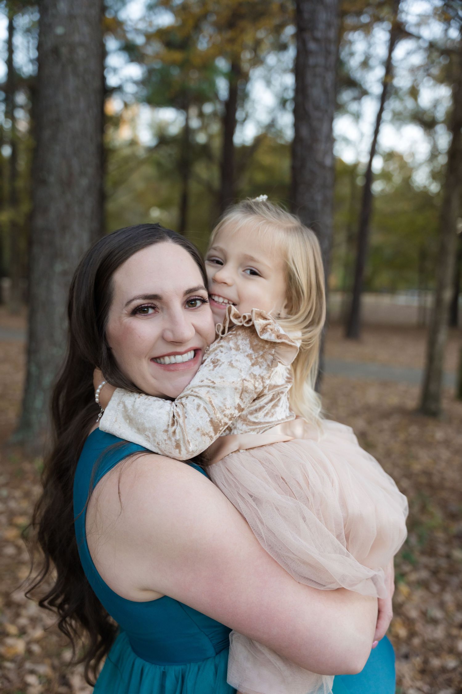 A sequence of four photos showing a tender embrace between two people in a wooded outdoor setting.