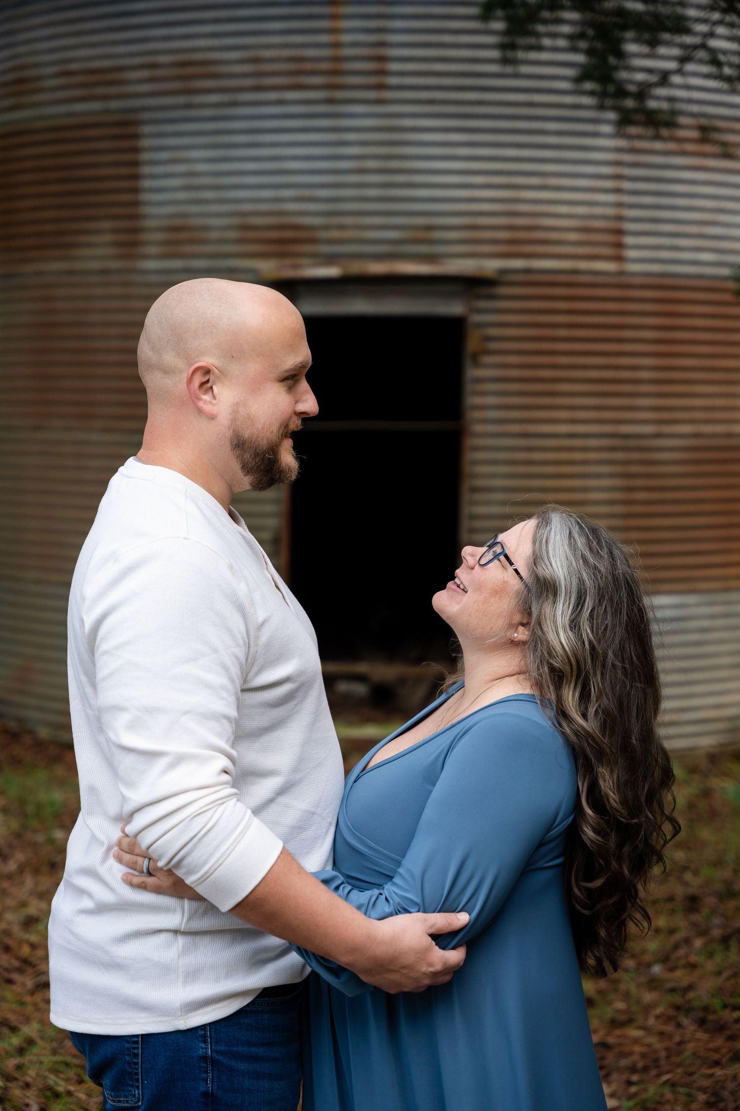 Intimate maternity photos taken against rustic corrugated metal background.