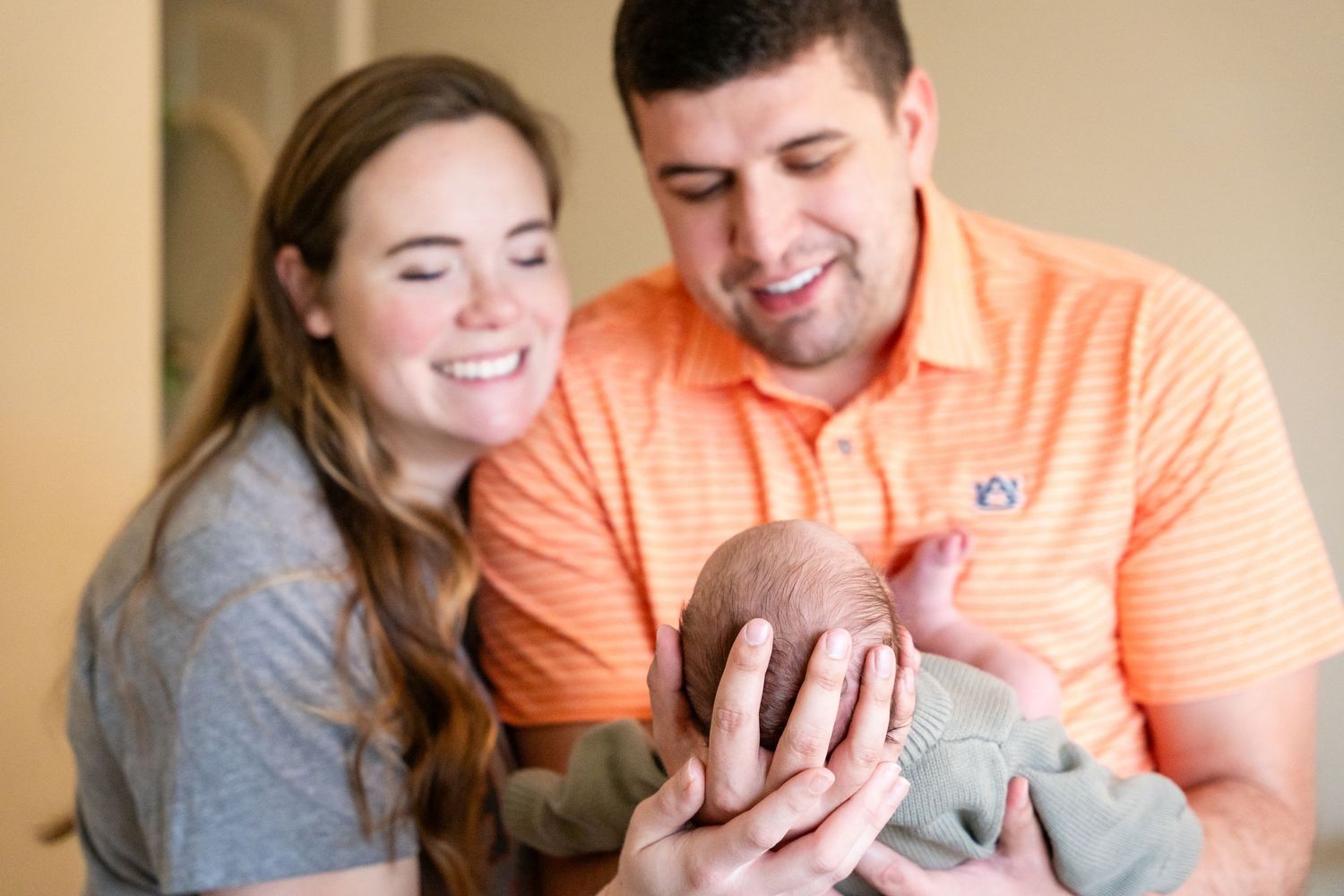 A joyful moment shared with a newborn in casual home setting.