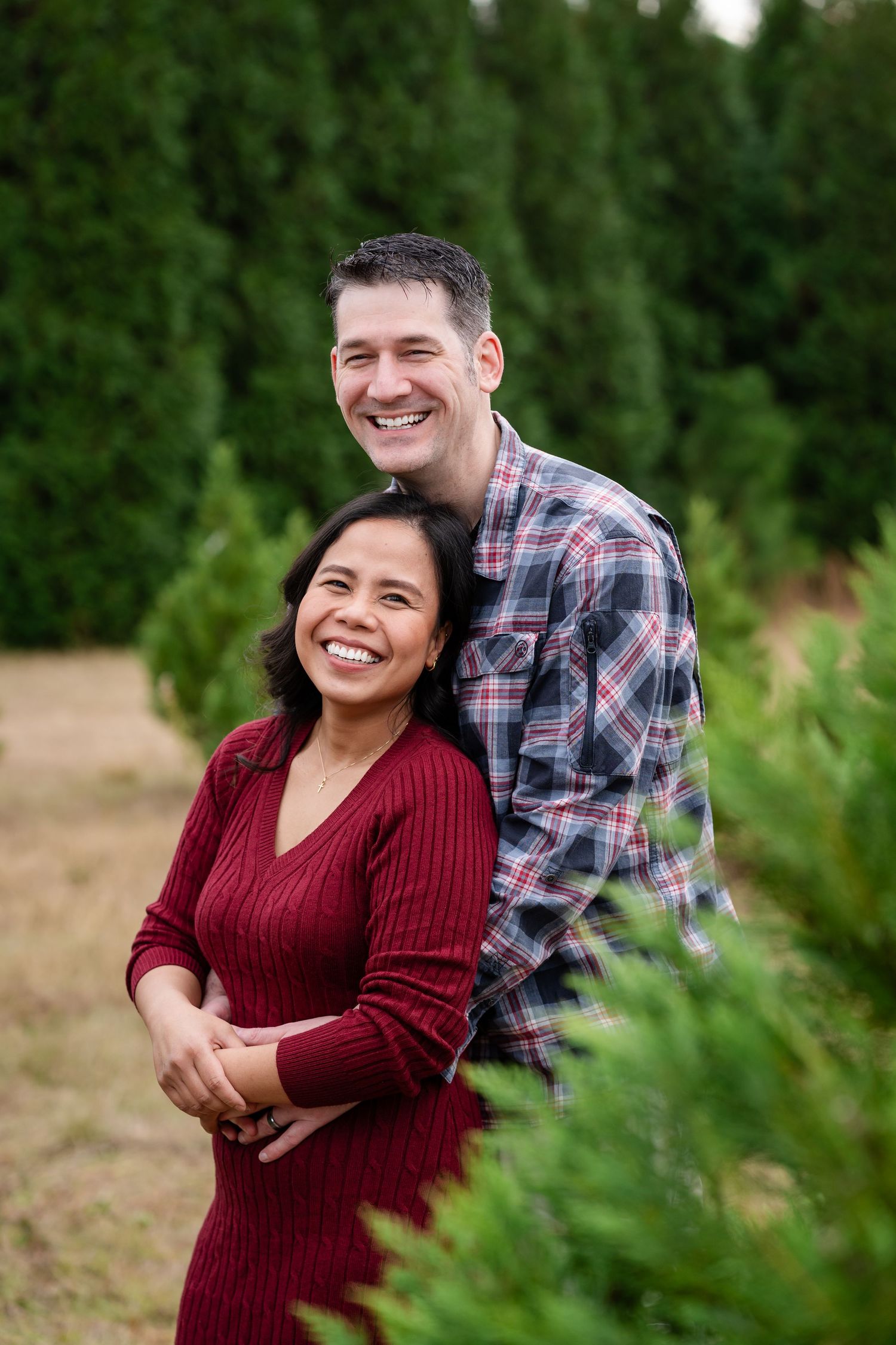 Joyful laughter shared between a couple during an outdoor photo session.