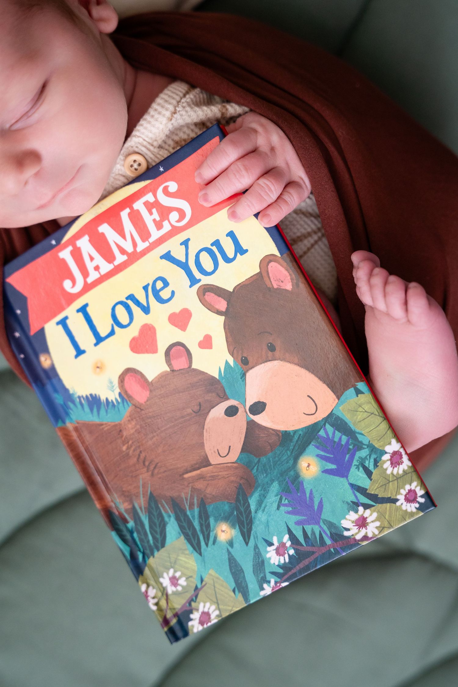 Sleeping baby next to children's book titled James I Love You with bear illustration.