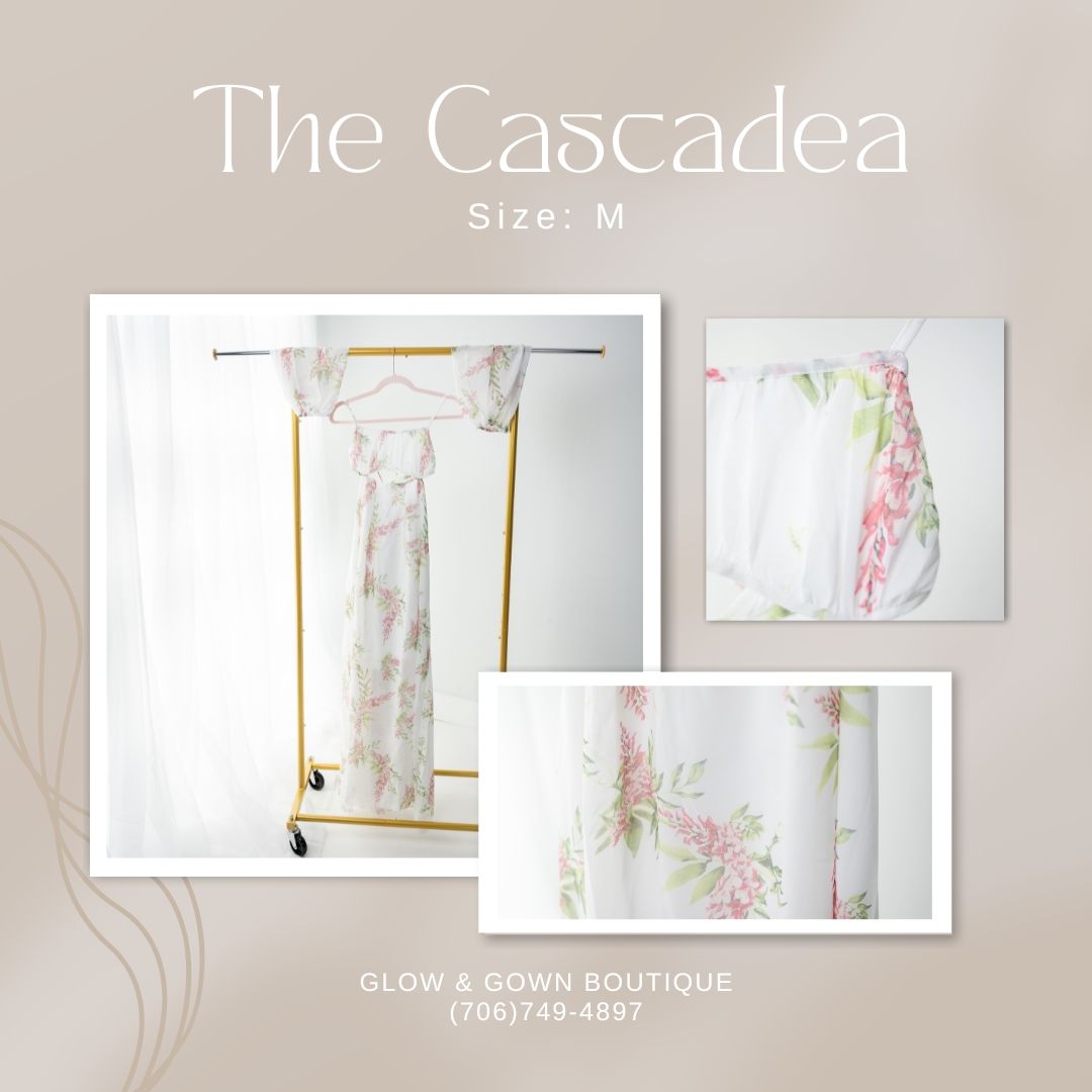 Floral print dress in soft pastel colors displayed in boutique setting.
