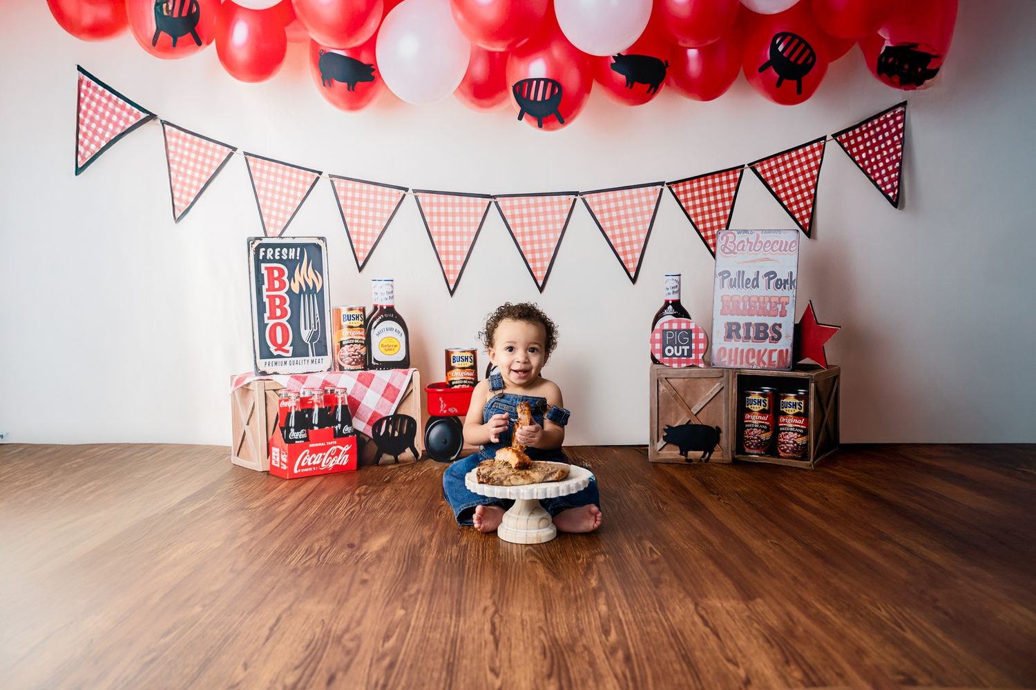 Birthday setup with red and white balloons and festive bunting decorations.