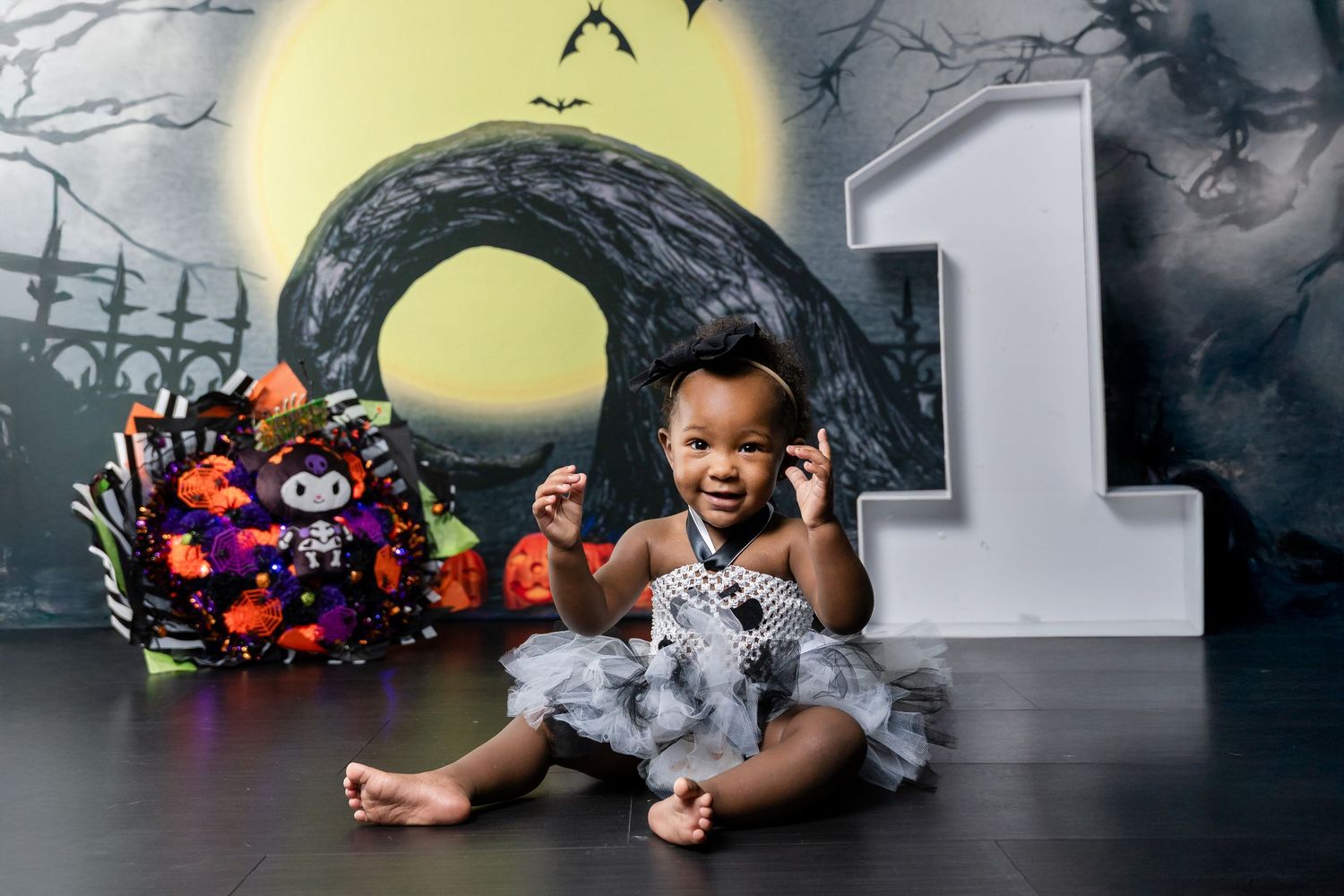 A series of five connected images showing a child in a tutu resting on a dark floor with colorful props and lighting.