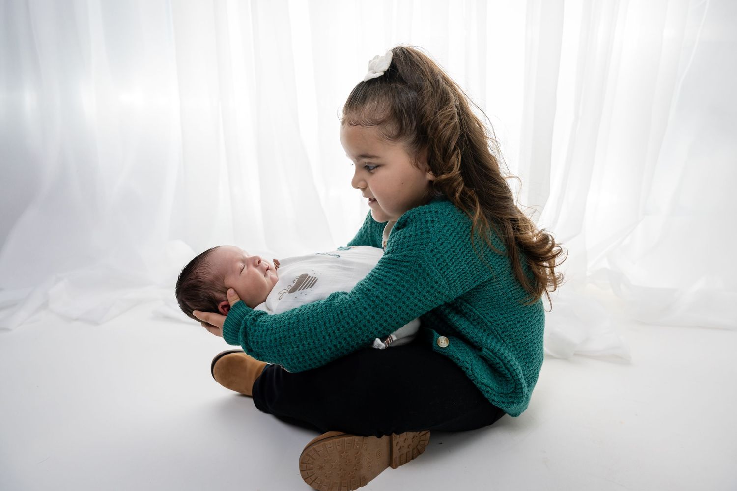 A bright and airy family photography session with white backdrop and natural lighting.