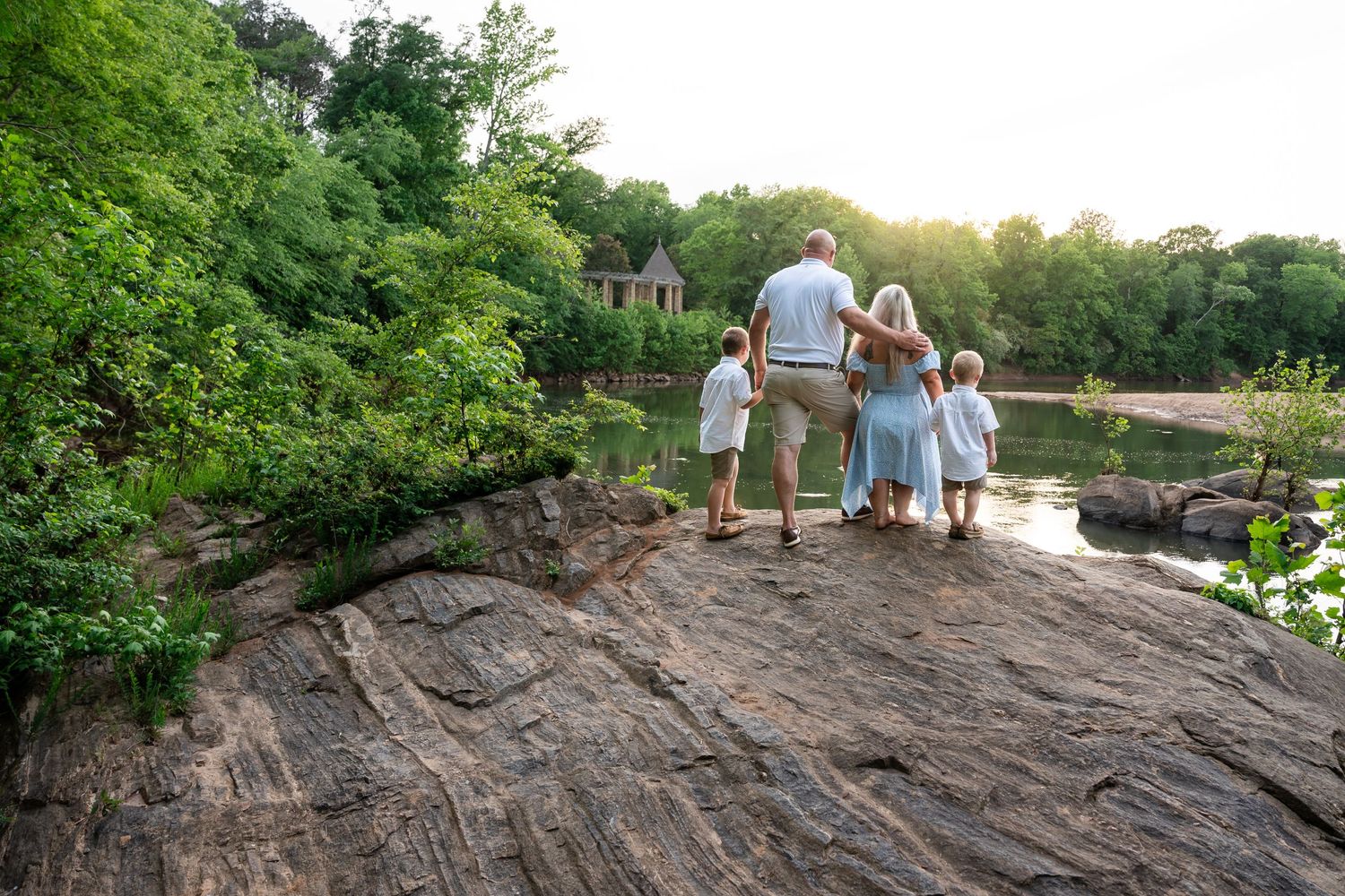 Wide landscape view of rocky formations along a lakeside park.