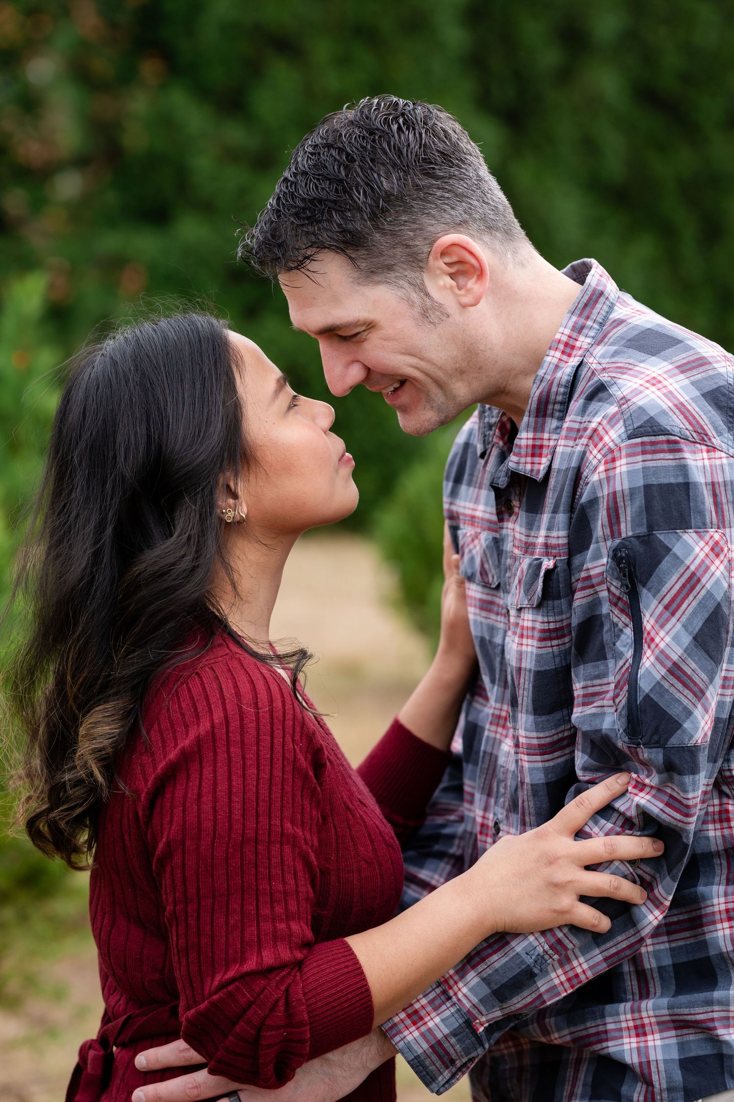 Intimate candid moments captured between a couple at a tree farm.