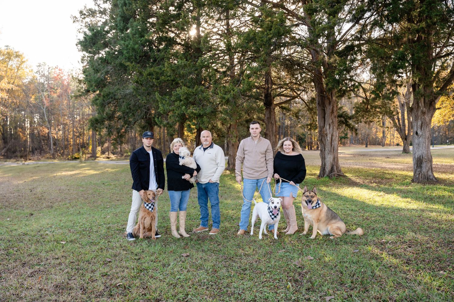 Group gathered outdoors for family photo session at sunset.