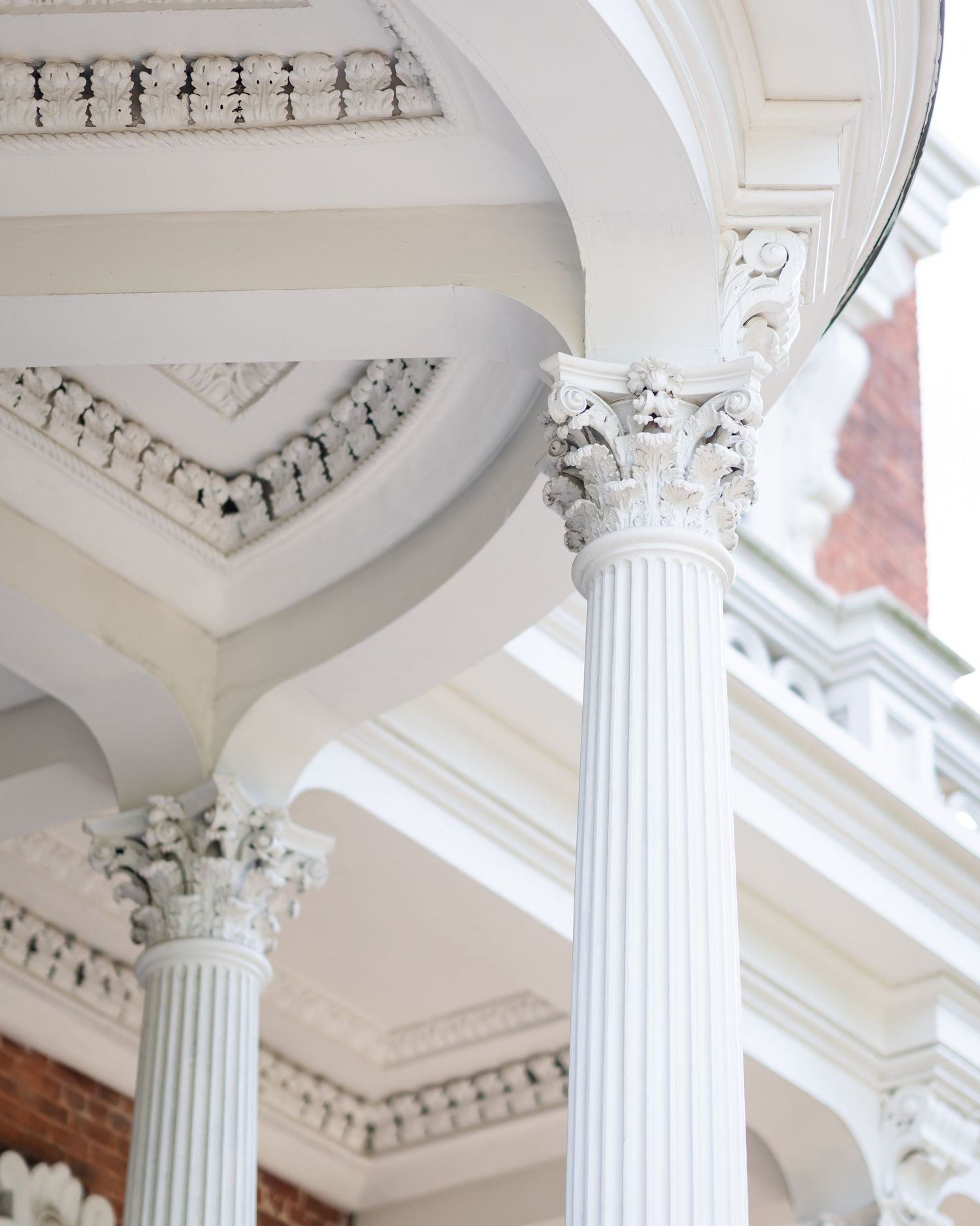 Architectural detail of white decorative columns and molding.