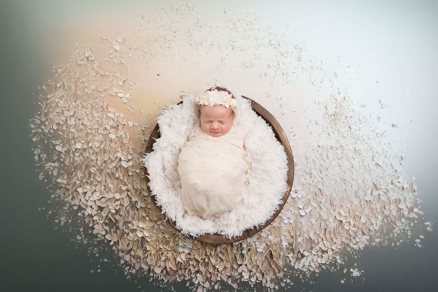 Artistic overhead shots showing baby surrounded by powdery white texture.