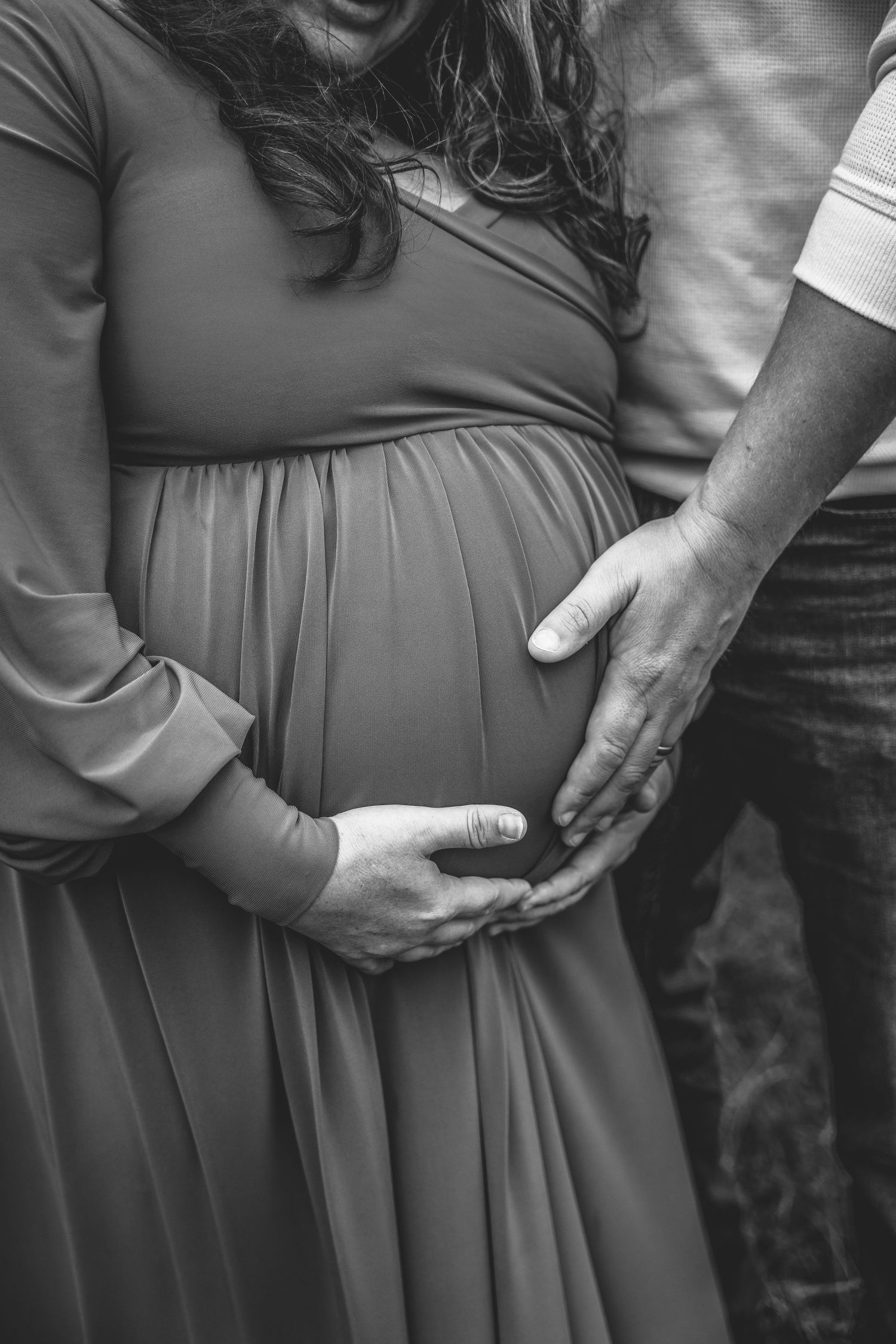 Series of intimate black and white maternity photos showing gentle belly holds.