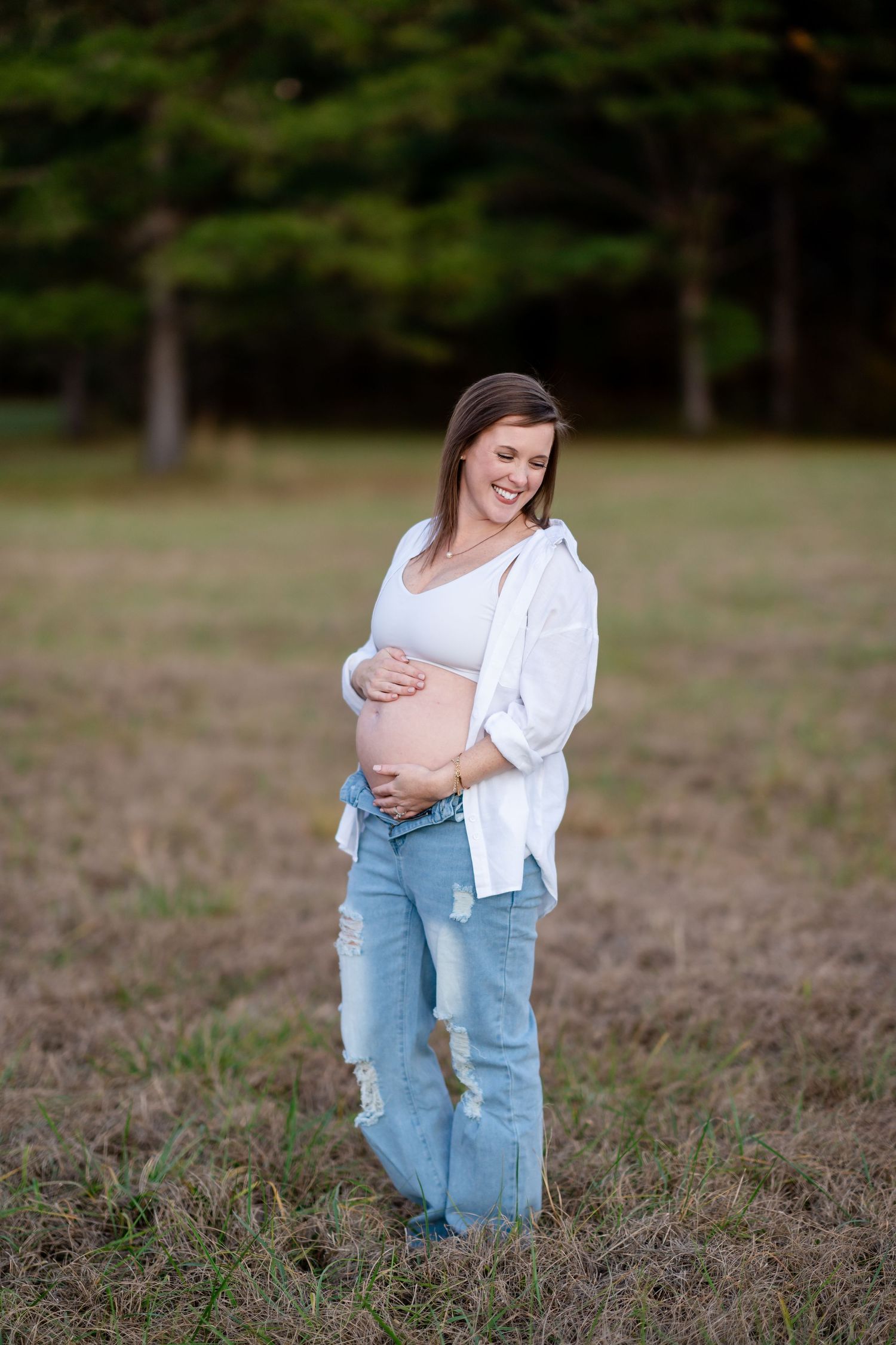 A candid maternity session in a natural outdoor setting.