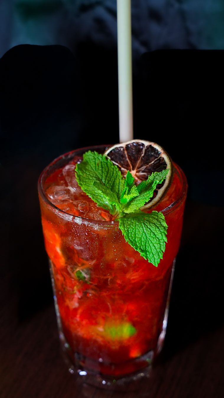 Fotografía gastronómica de cóctel con frutos rojos y menta