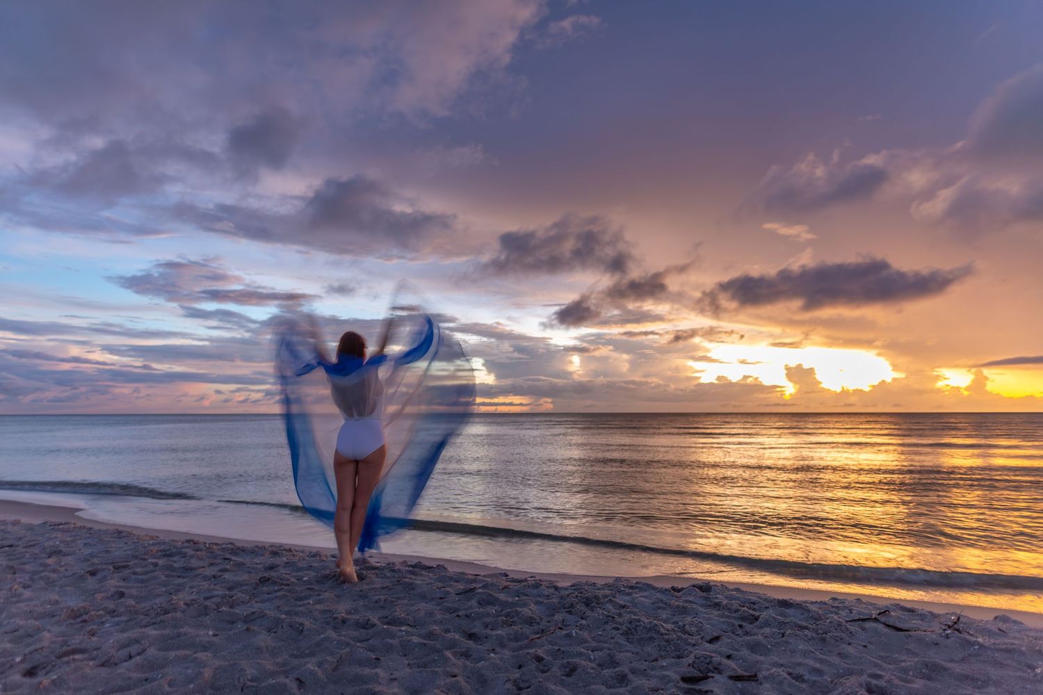 Silhouetted figure performs graceful dance poses against vibrant beach sunset creating artistic seaside portraits.