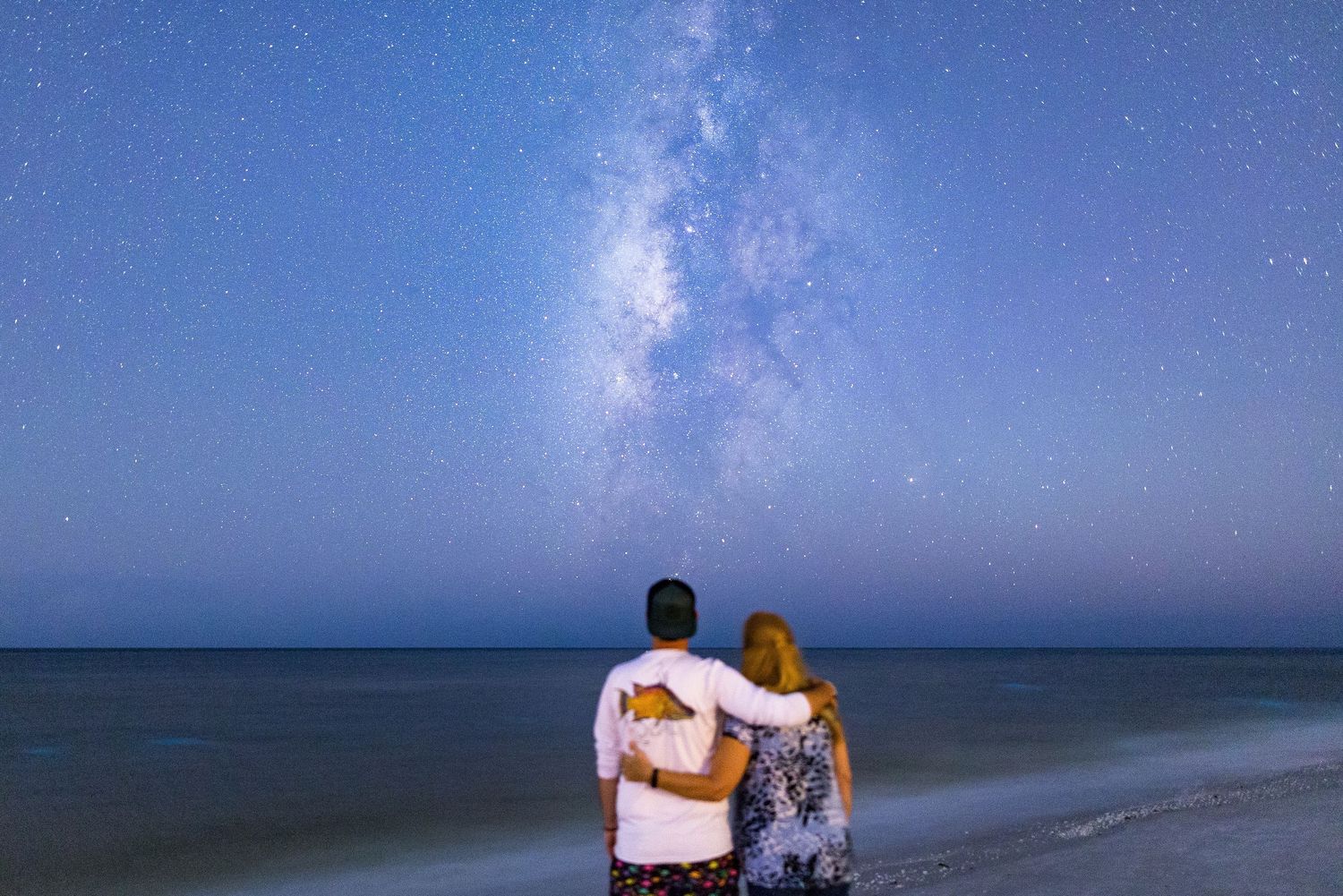 A collection of stunning night sky photographs showing the Milky Way over various landscapes and seascapes.