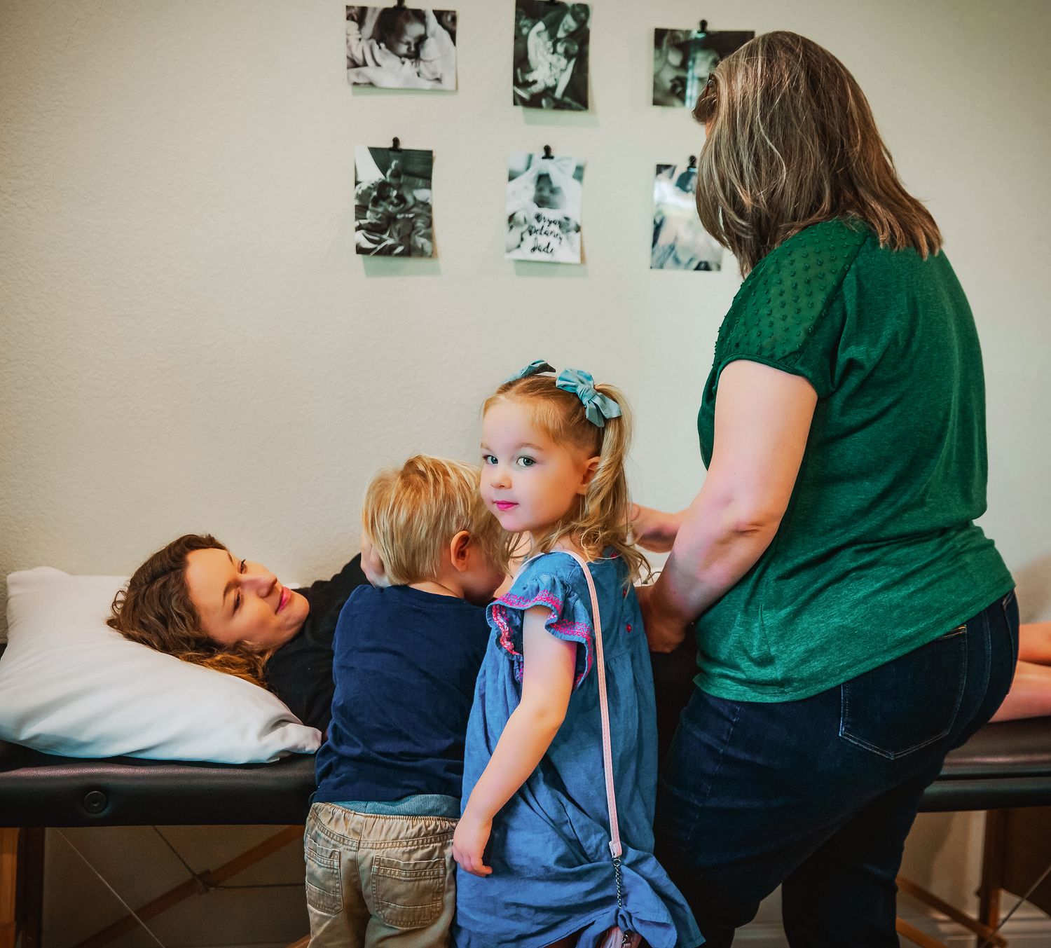 Young siblings at prenatal appointment at midwife's office. Listening to baby's heartbeat. Decatur Texas.