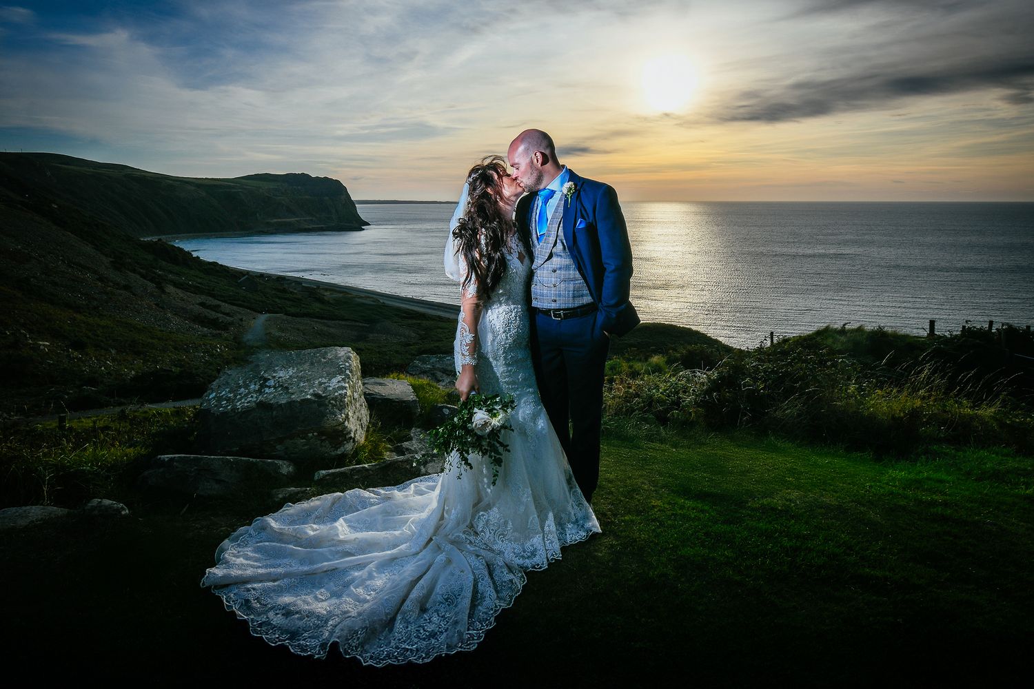 Glorious sunset kiss looking out to sea from the Llyn Peninsula; romantic North Wales wedding.