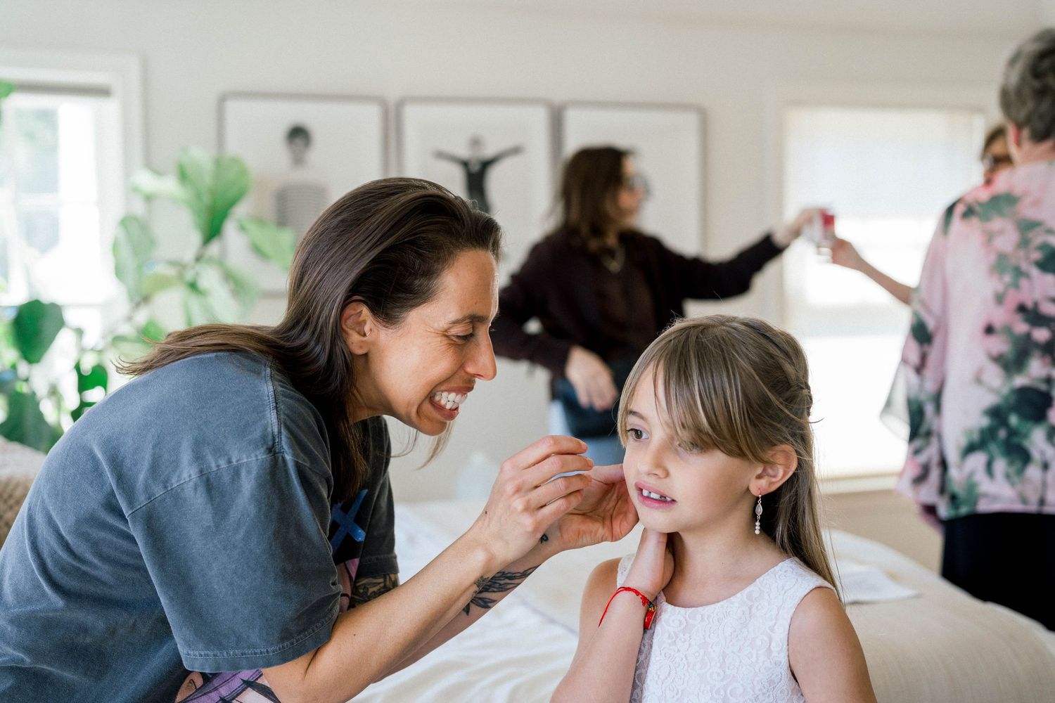 Bride helping daughter with earrings