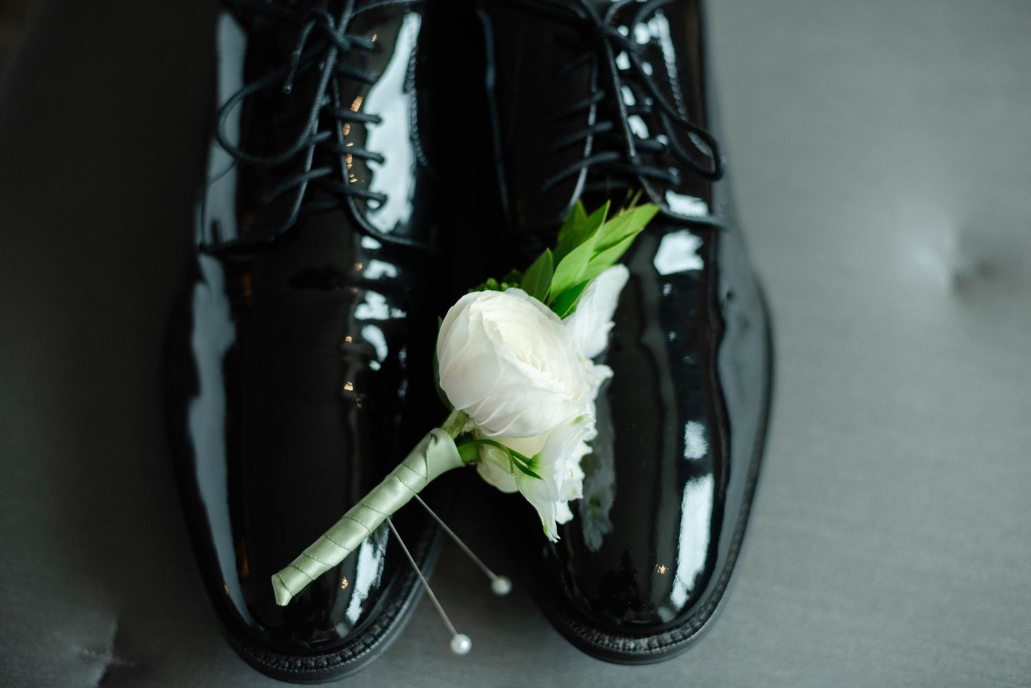 Grooms shoes with boutonnière.