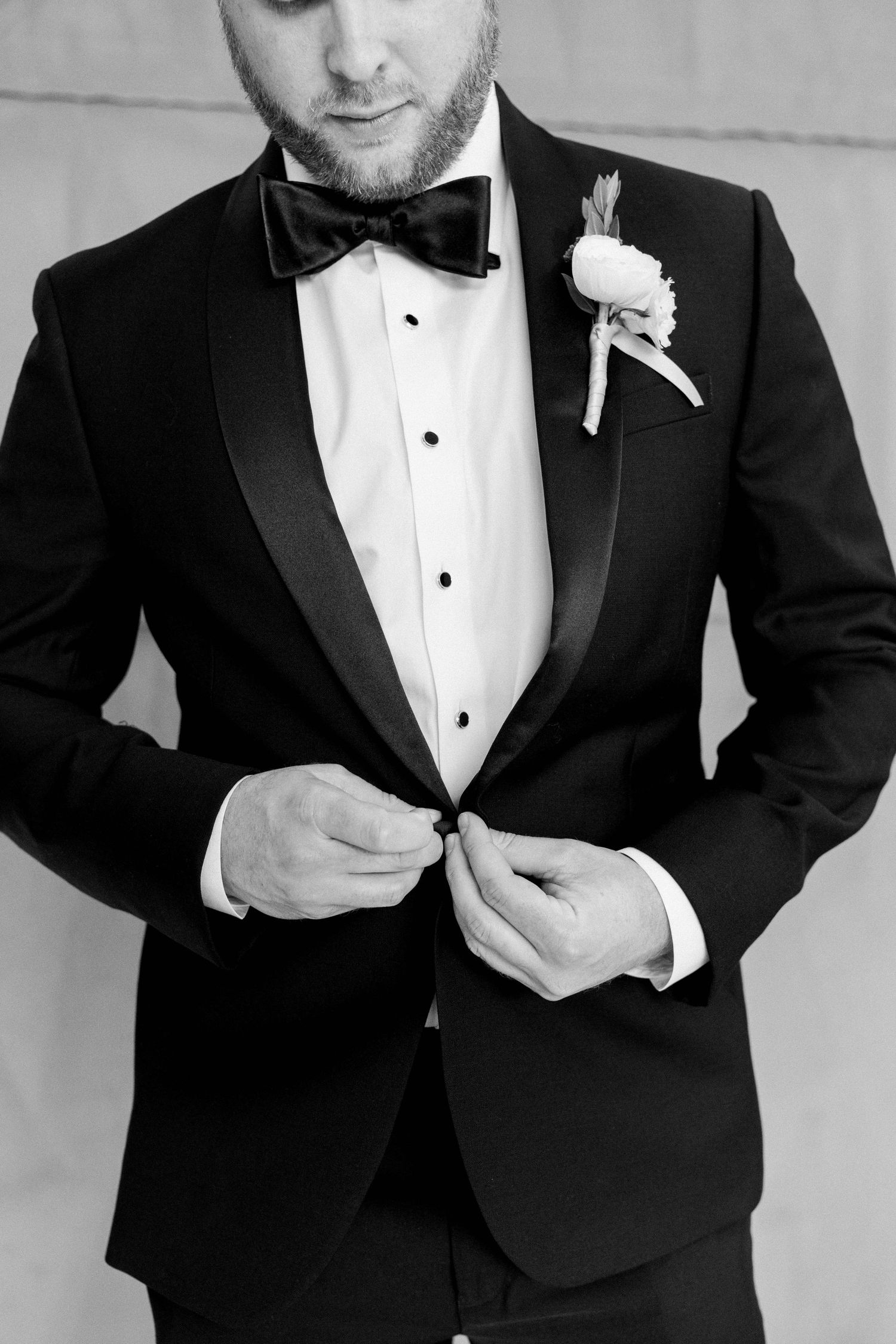 Groom buttoning coat at Regency Hyatt Hotel Wedding, Tysons Corner, Virginia.