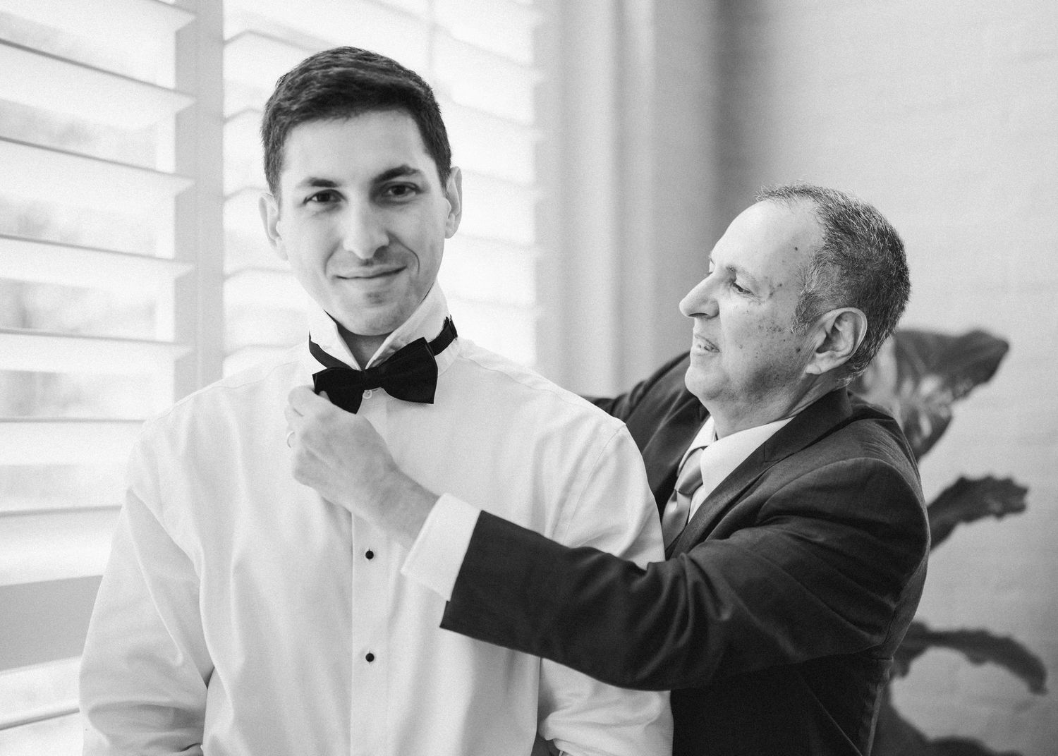 Black and white photo of groom getting ready with his father- Airlie, Warrenton, Virginia