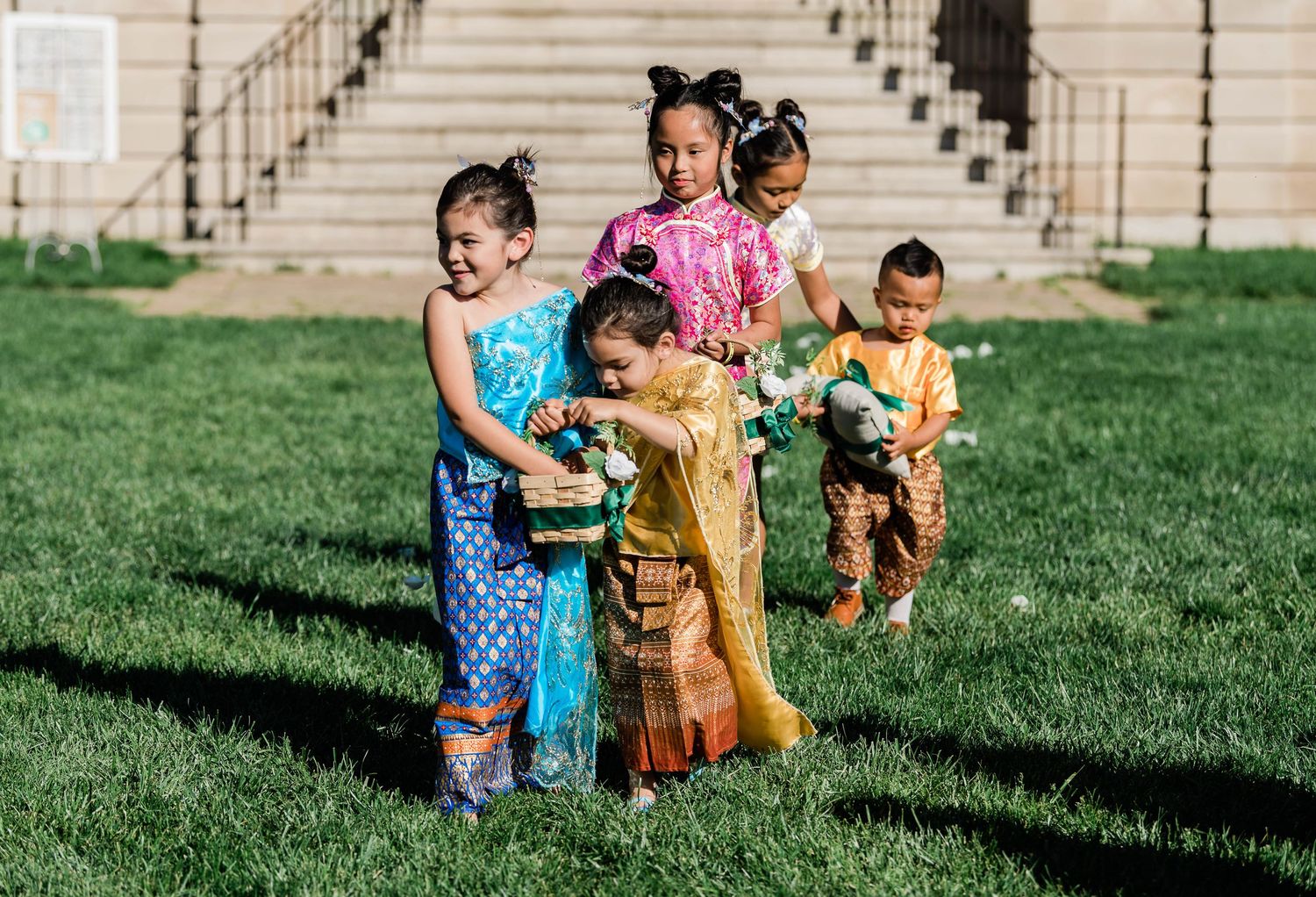 The cutest flower girls and boy, dressed in traditional Chinese and Thai outfits