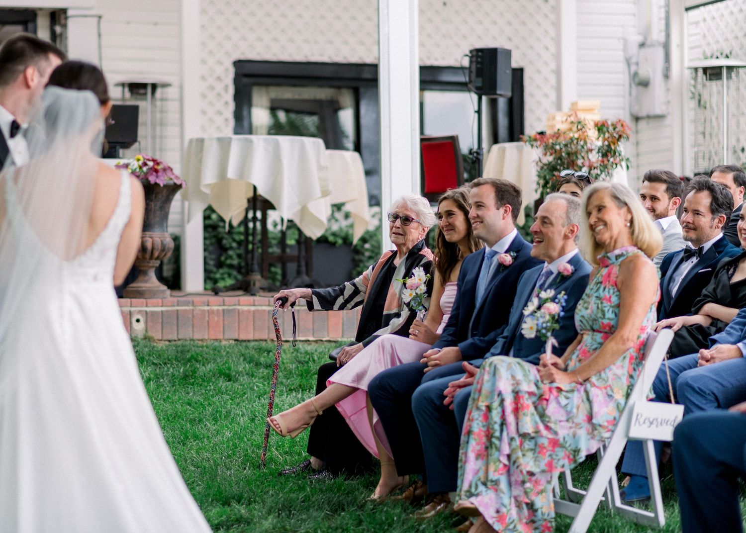 Guests laughing, including a sweet moment where grandma is crying, during a wedding ceremony at Cedar Knoll in Alexandria, Virginia.