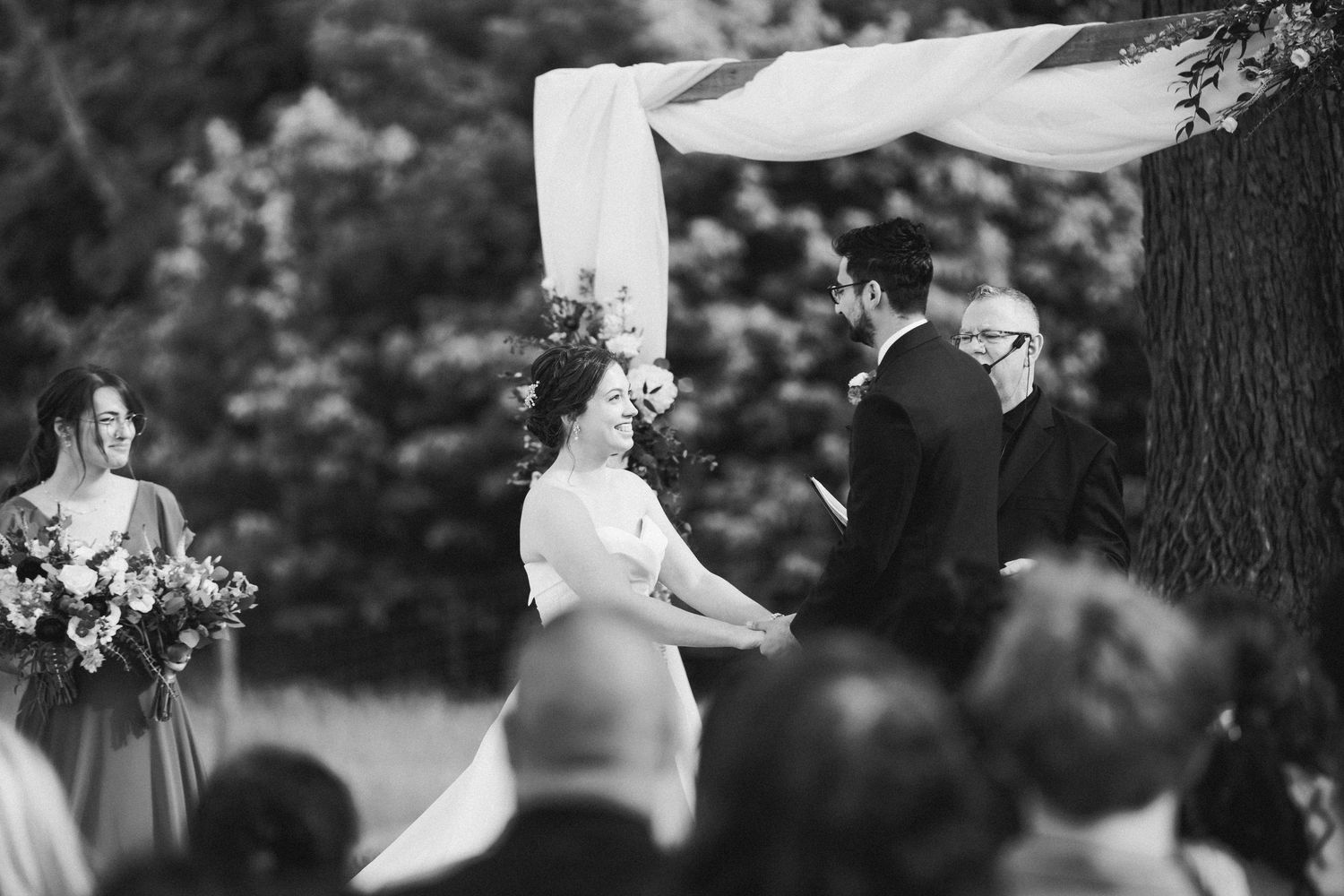 The bride smiling during the wedding ceremony at Old Farm Winery.
