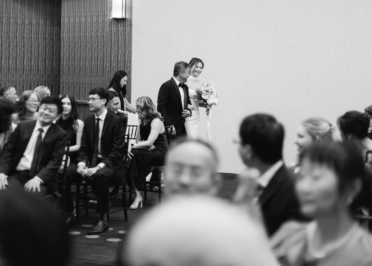 Bride and her father coming down the aisle in black and white.
