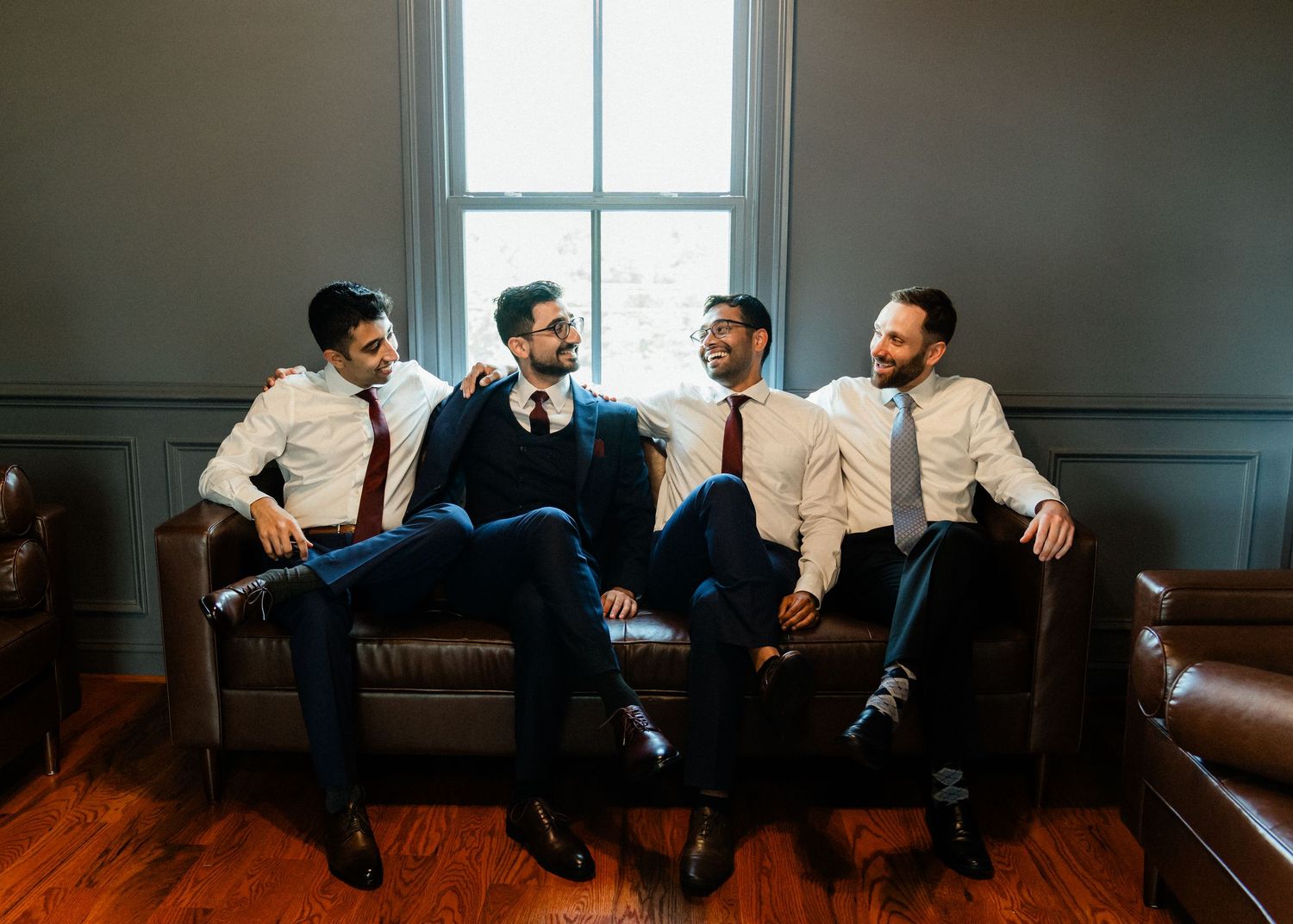 Groom and his groomsmen enjoying a laugh at Old Farm Winery.