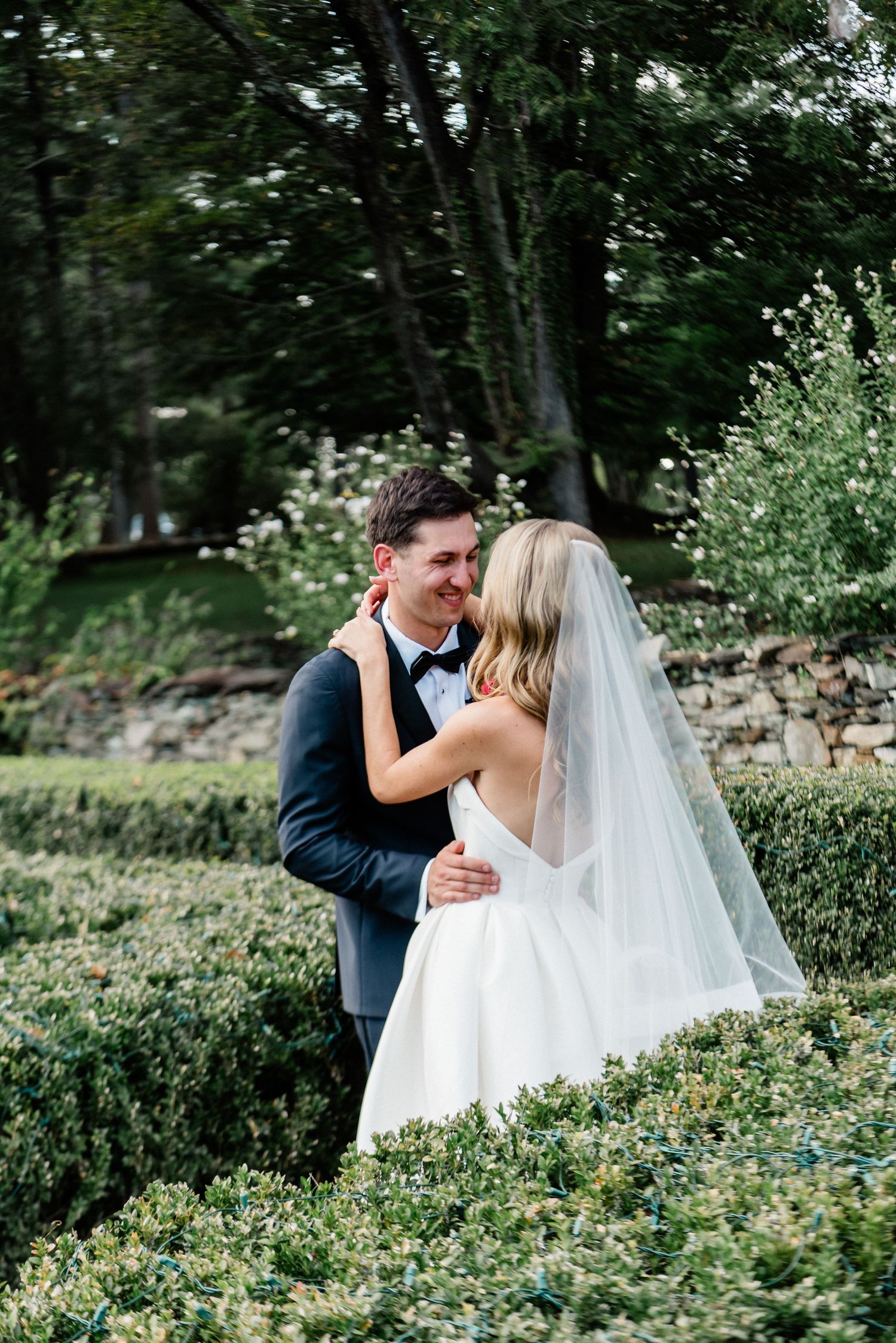 Couple enjoying a private moment in the boxwood garden- Airlie, Warrenton, Virginia
