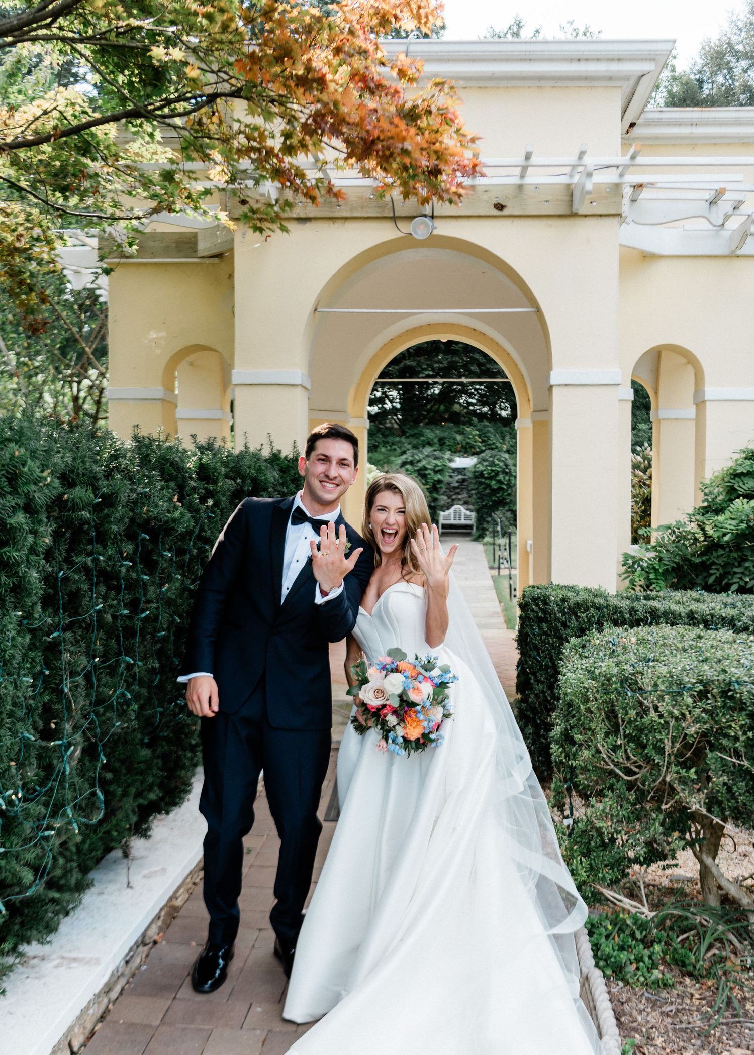 Wedding couple flashing their wedding rings post ceremony at Airlie in Warrenton, Virginia