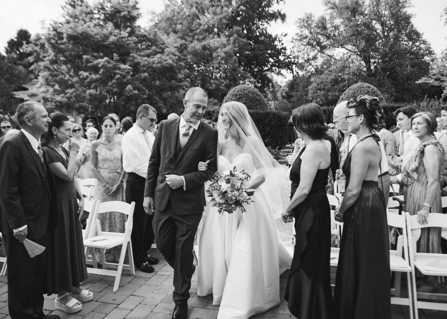 Black and white portrait of bride coming down the aisle with her father- Airlie, Warrenton, Virginia