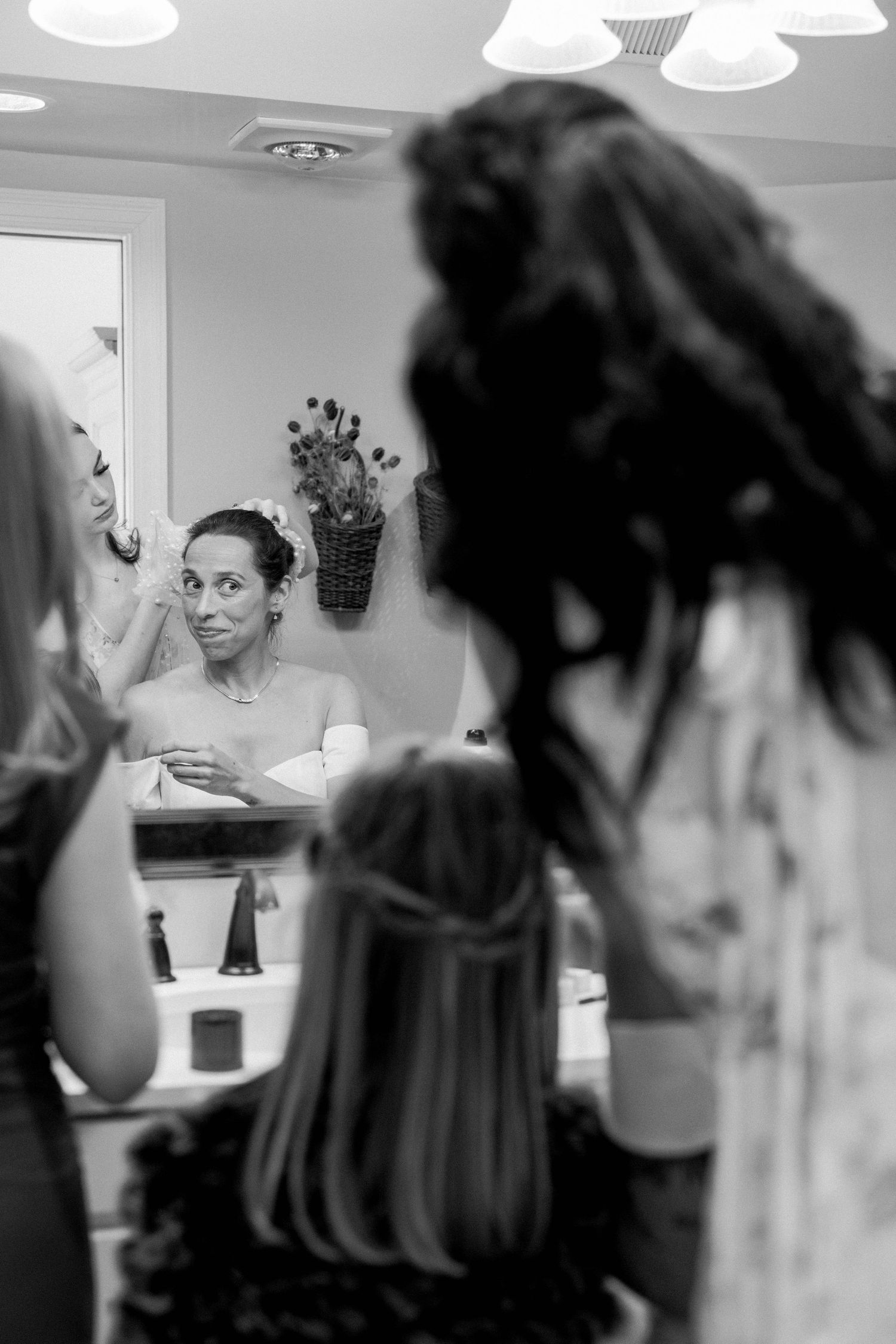 The bride getting veil fitted.
