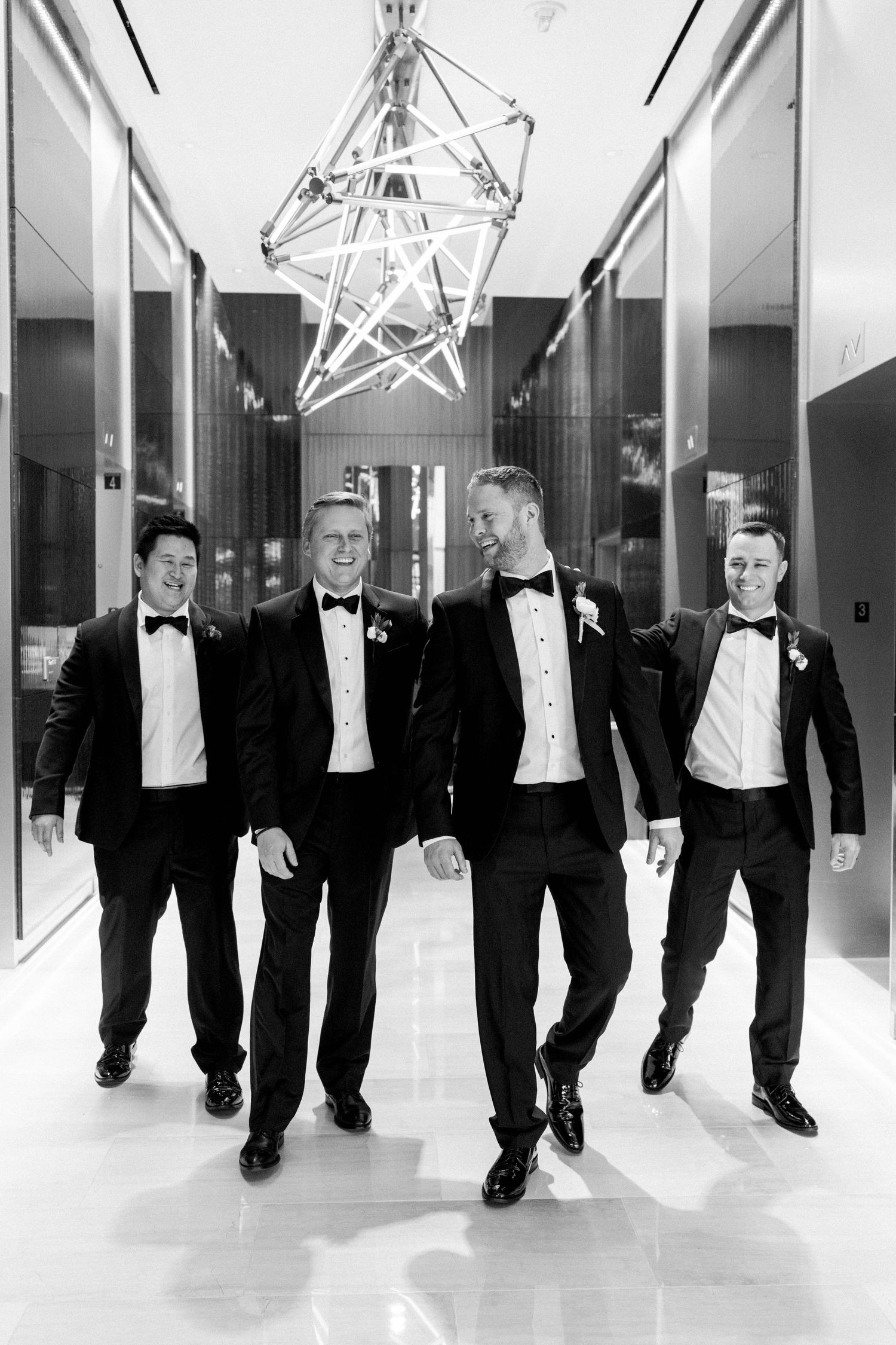 Groomsmen and groom walking in the Hyatt Regency of Tysons Hotel.