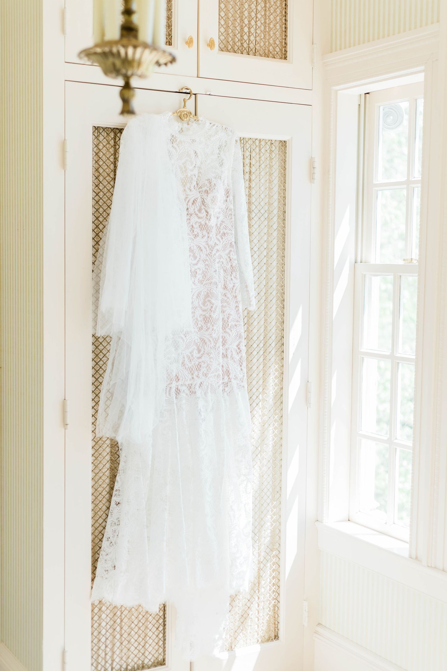 Bride's lace covered, fitted wedding gown, Great Marsh Estate bridal suite