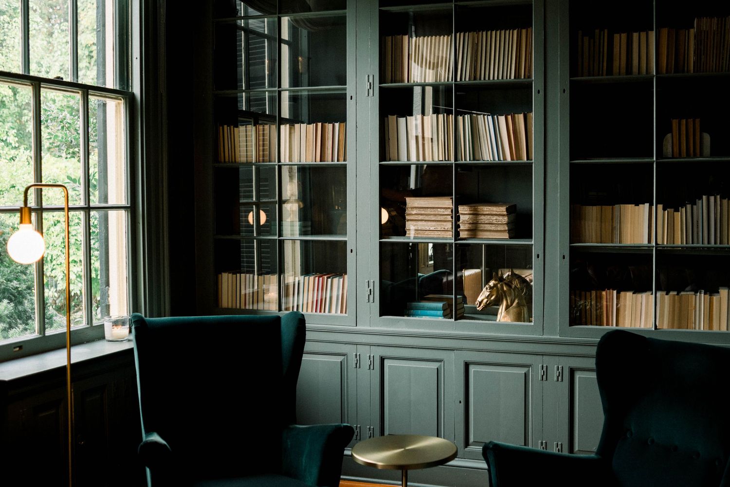 Beautiful green hued library at Rust Manor House