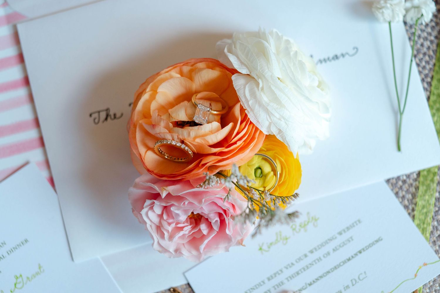 Wedding bands on top of florals, flat-lay photo, Omni Shoreham Hotel wedding.