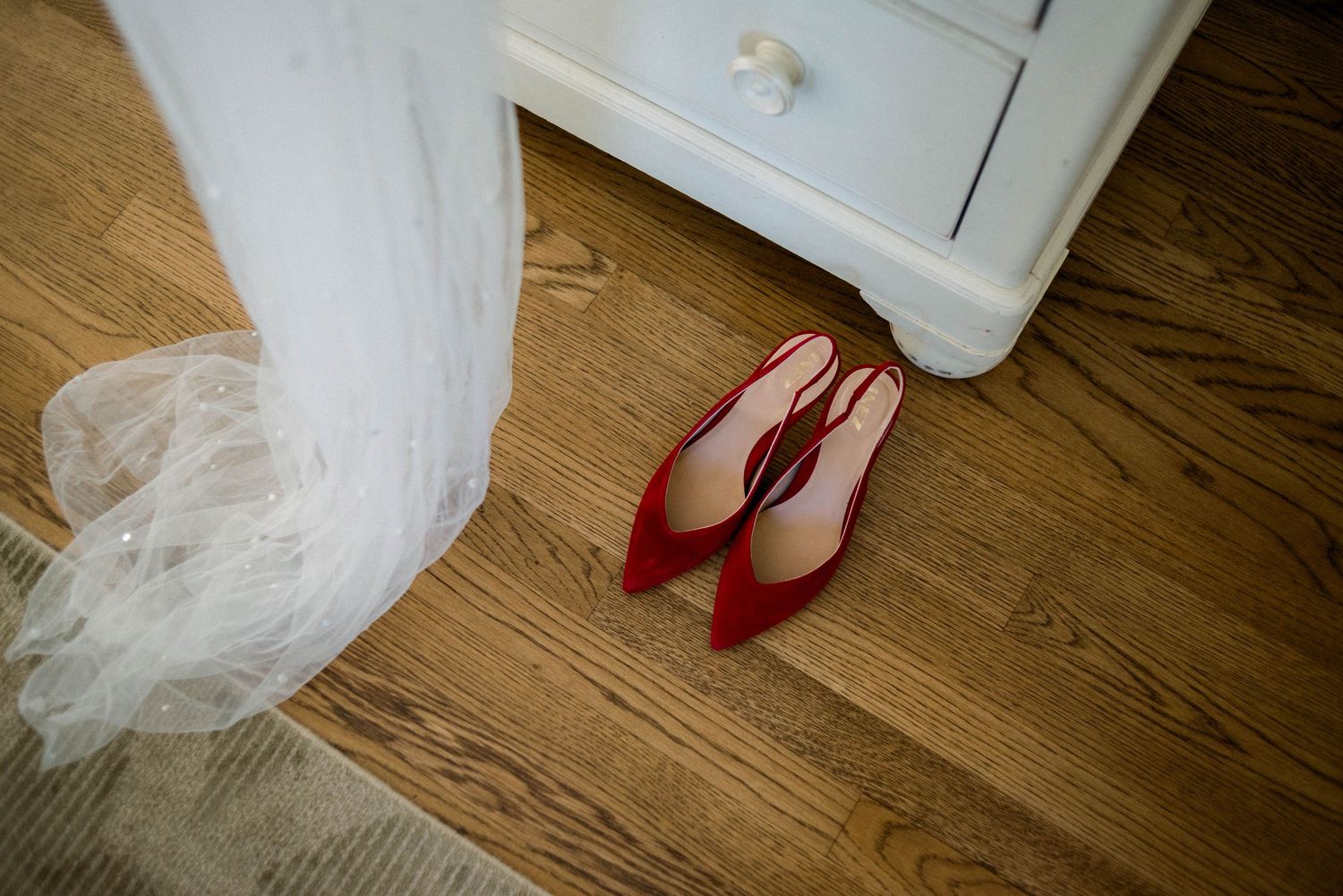 The bride's red heels and veil.