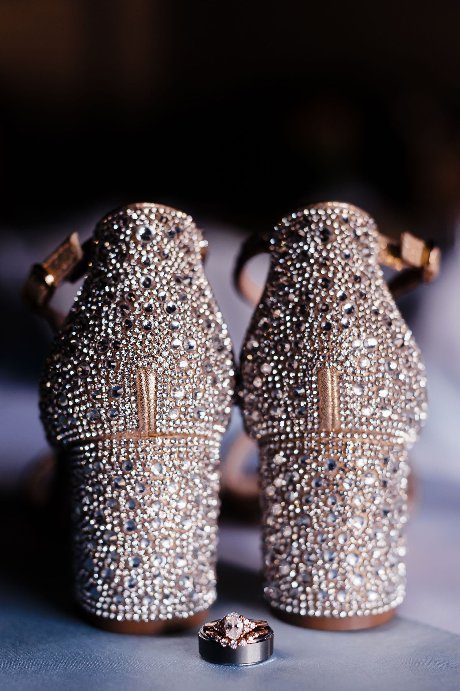 Pair of crystal-encrusted high heel shoes with intricate rhinestone details on display.