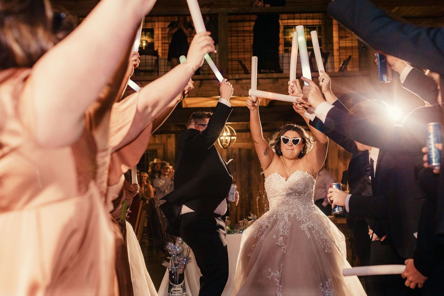 Wedding celebration on dance floor with soft lighting and festive atmosphere.