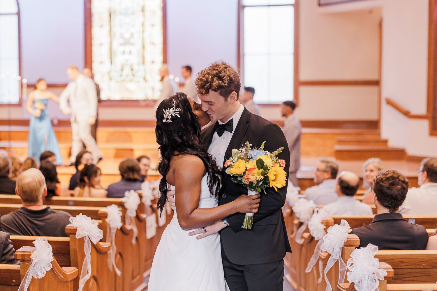 Traditional church wedding ceremony with elegant decor and floral arrangements.