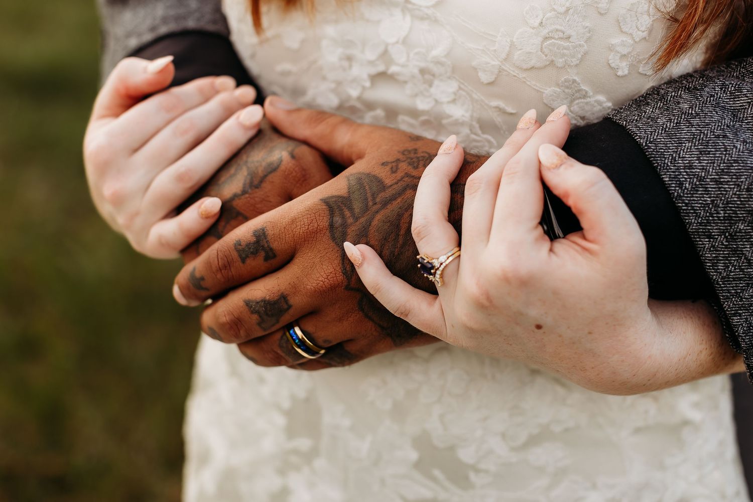 Close-up of hands with wedding rings in intimate moment.