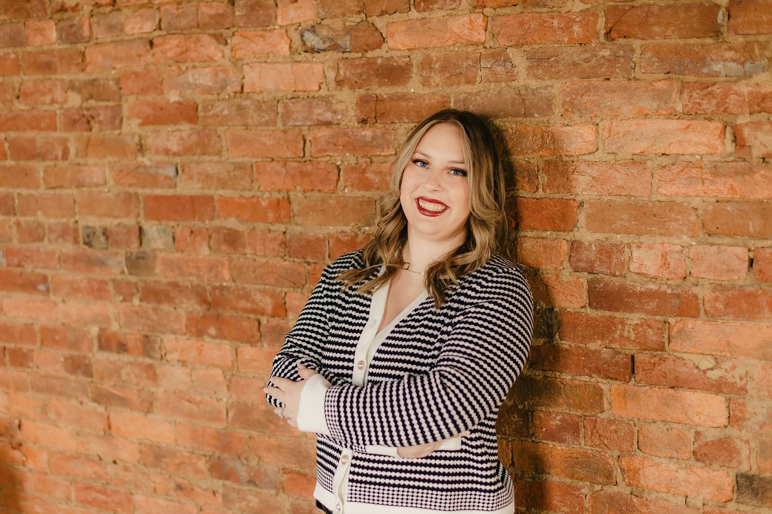 Series of portraits against a rustic brick wall background.