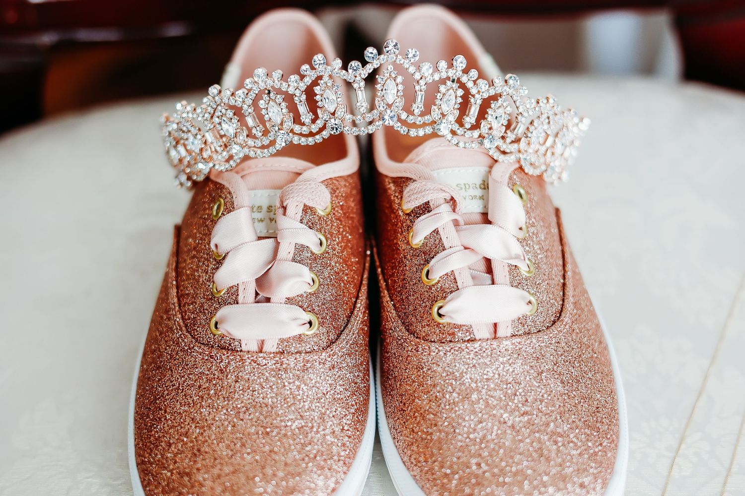 Rose gold glittery baby shoes lined up in a row.