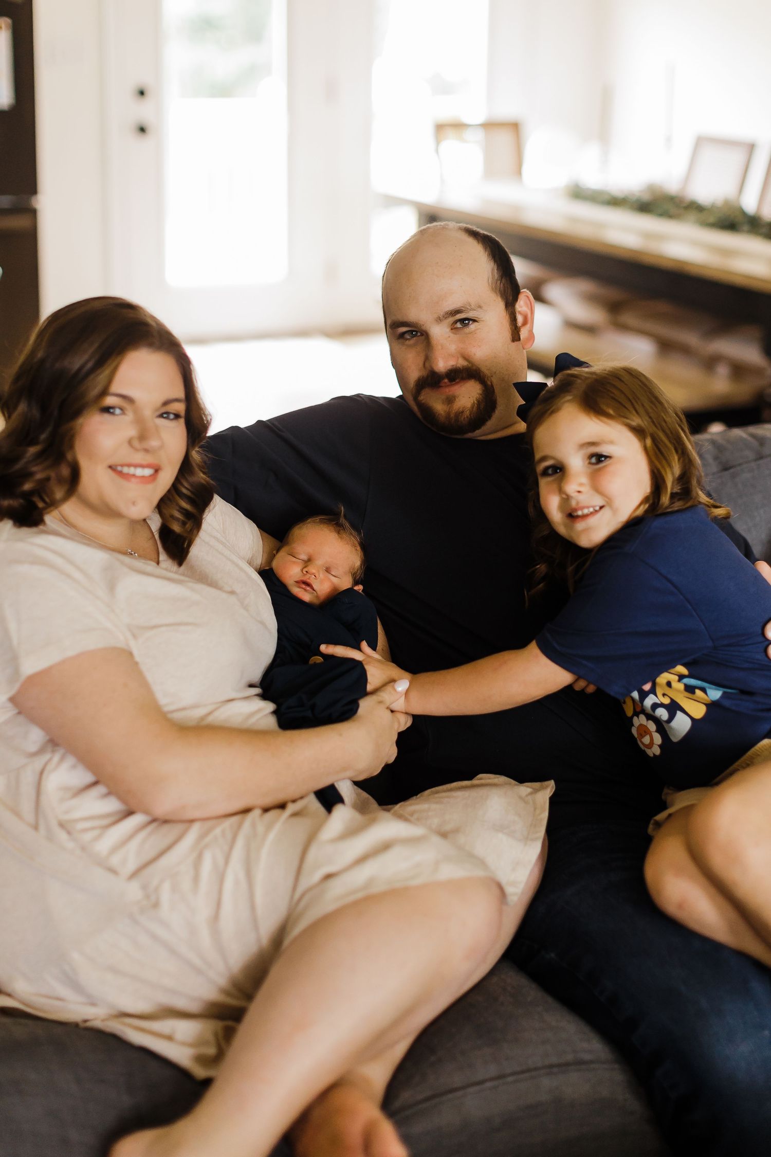 A cozy lifestyle photoshoot showing intimate moments on a bed with white linens.
