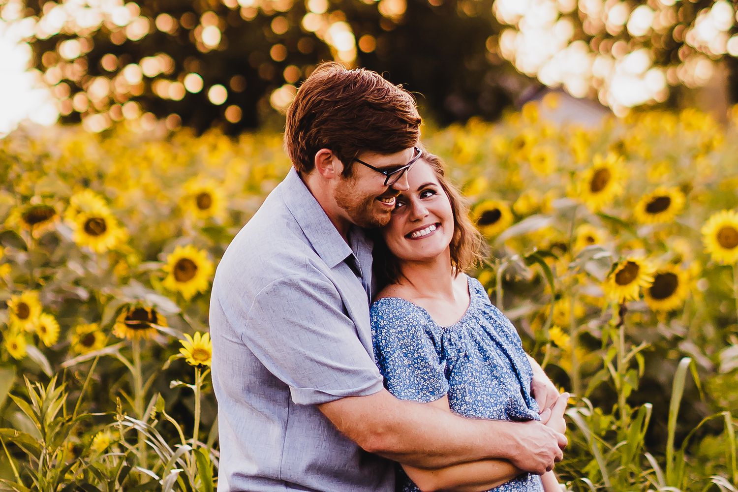 Romantic couple photos in a sunflower field at sunset.