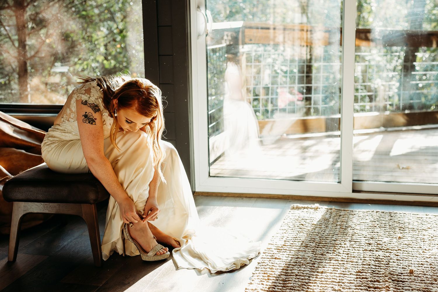Sunlit indoor portrait with natural window lighting creating soft ambiance.
